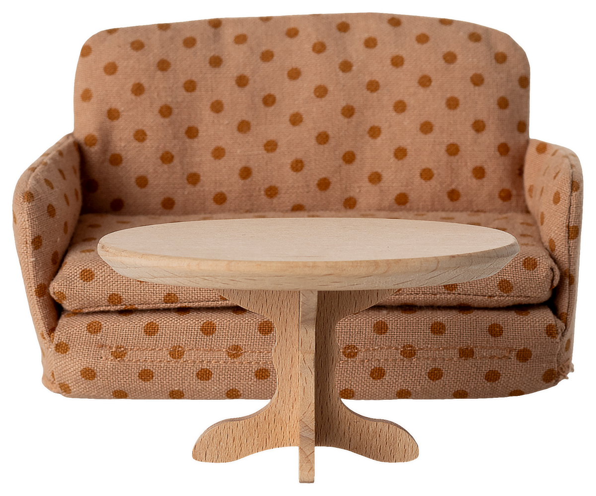 Polka dot sofa with a round wooden table on a white background.