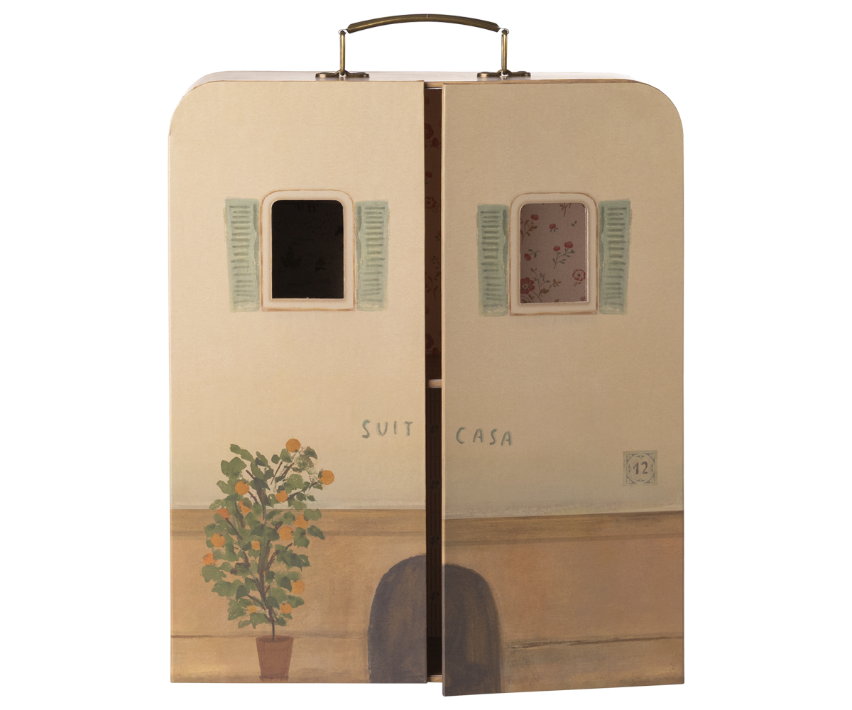 Cardboard box designed to resemble a house with windows and a plant, featuring the brand &