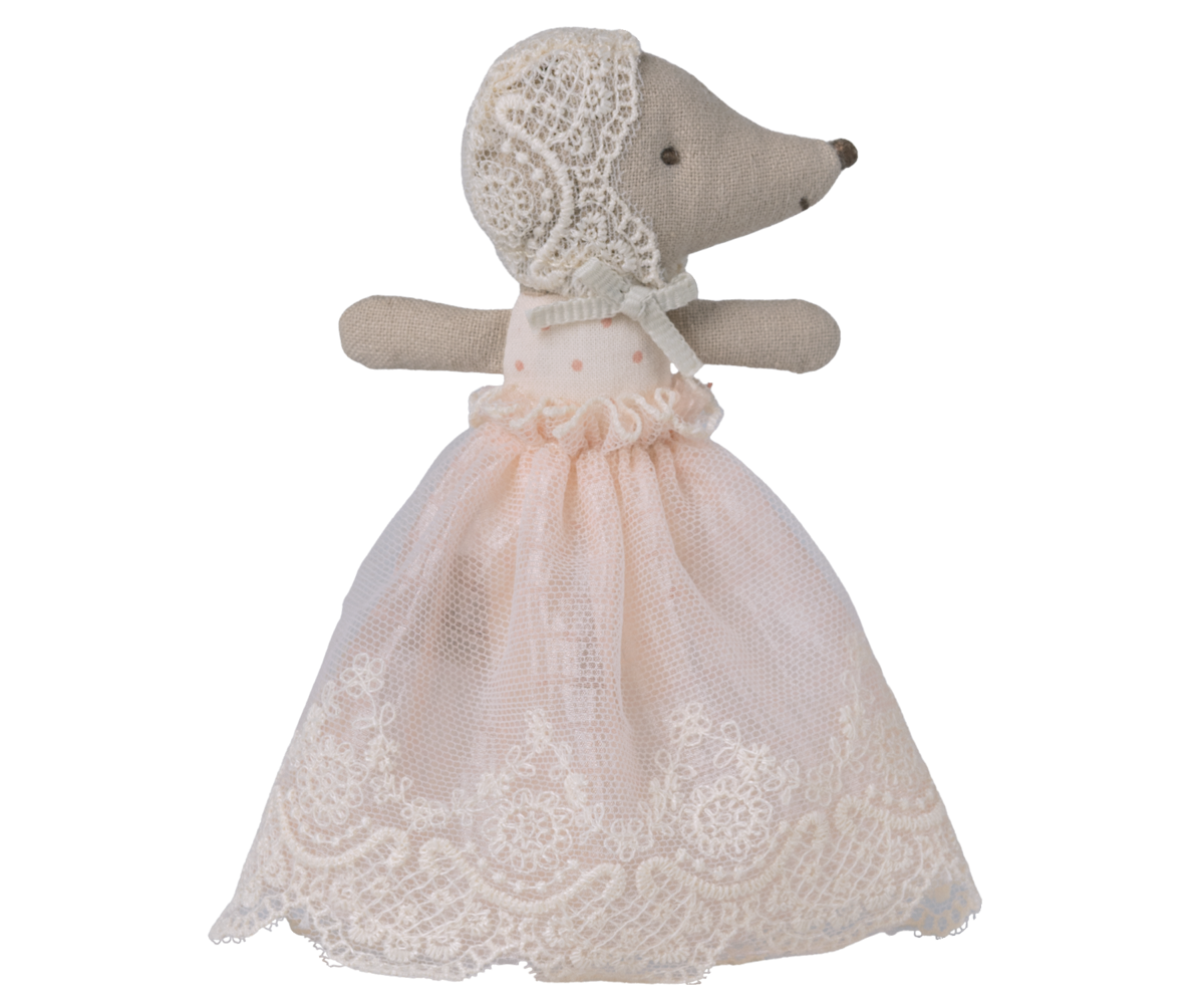 Stuffed animal toy with a lace dress on a white background