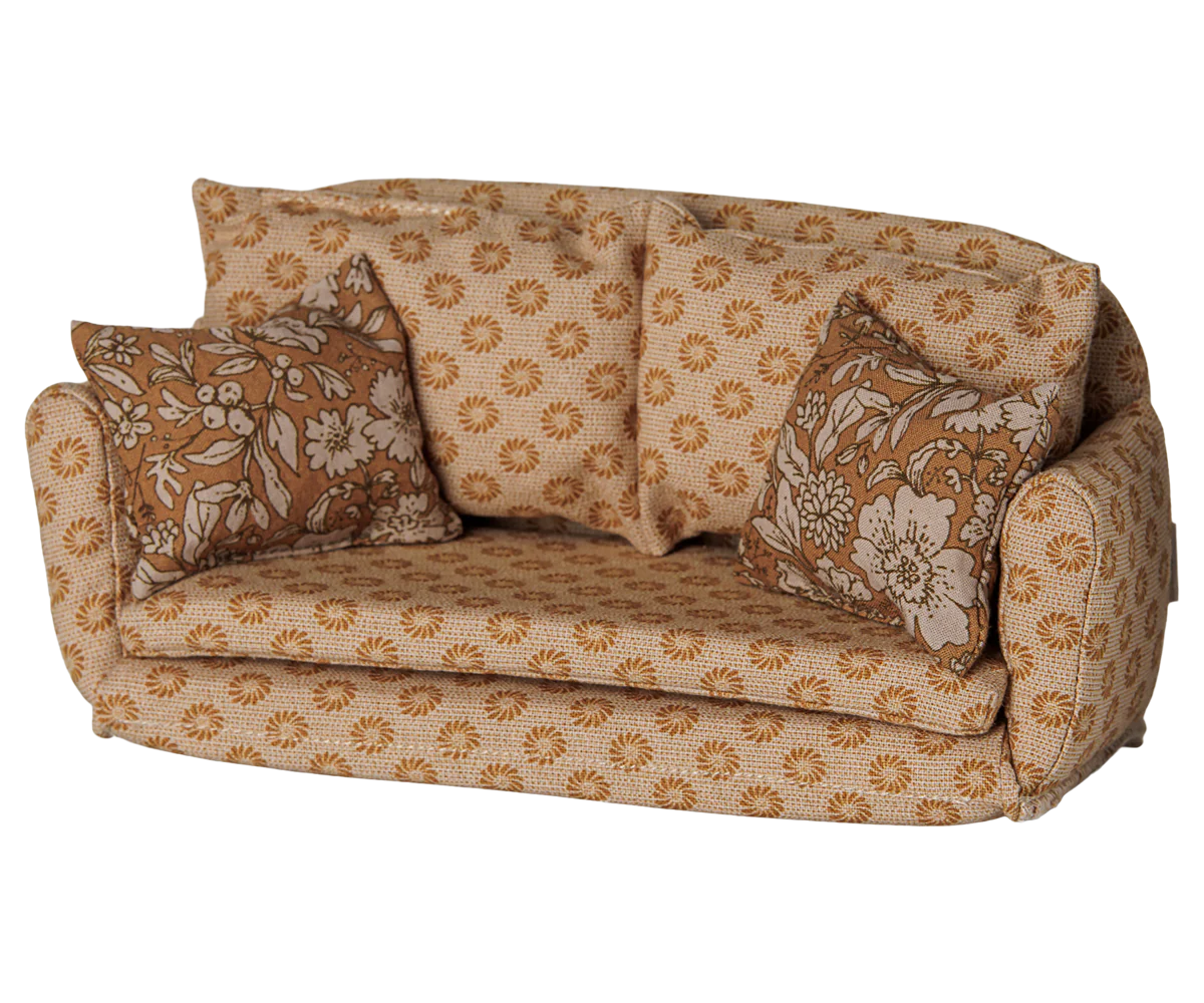 A vintage-style fabric miniature couch with a beige and brown floral pattern, featuring two matching patterned throw pillows, shown against a plain white background.