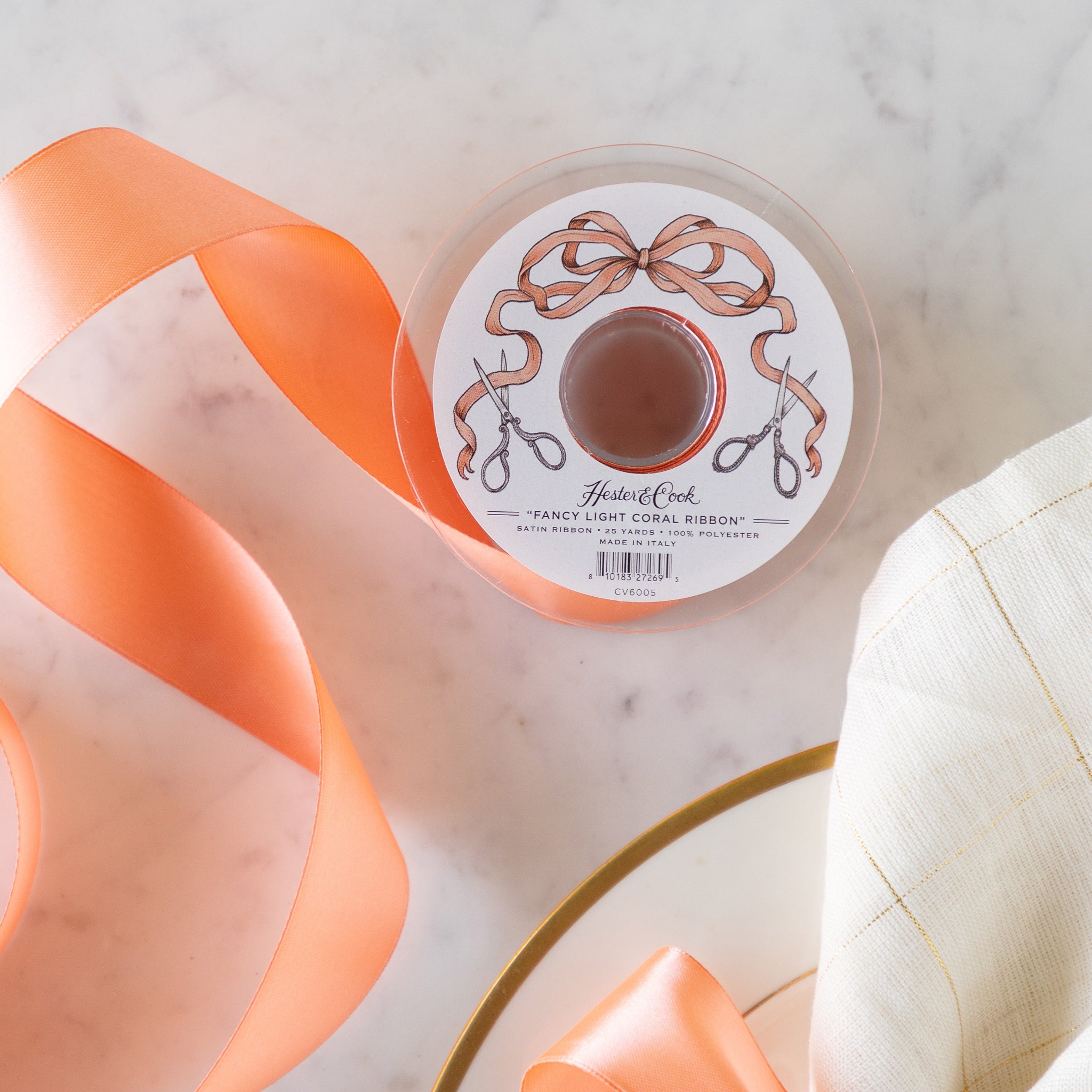 A spool of the Fancy Light Coral Ribbon unrolled.