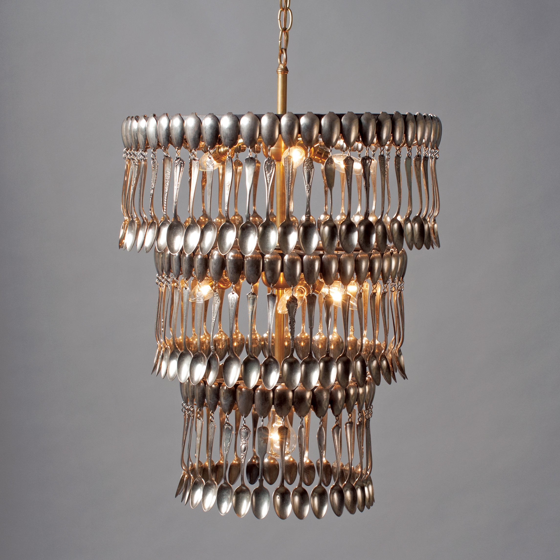 Triple Tier Spoondelier, a chandelier made of silver spoons, on a gray background, made by Hester & Cook.