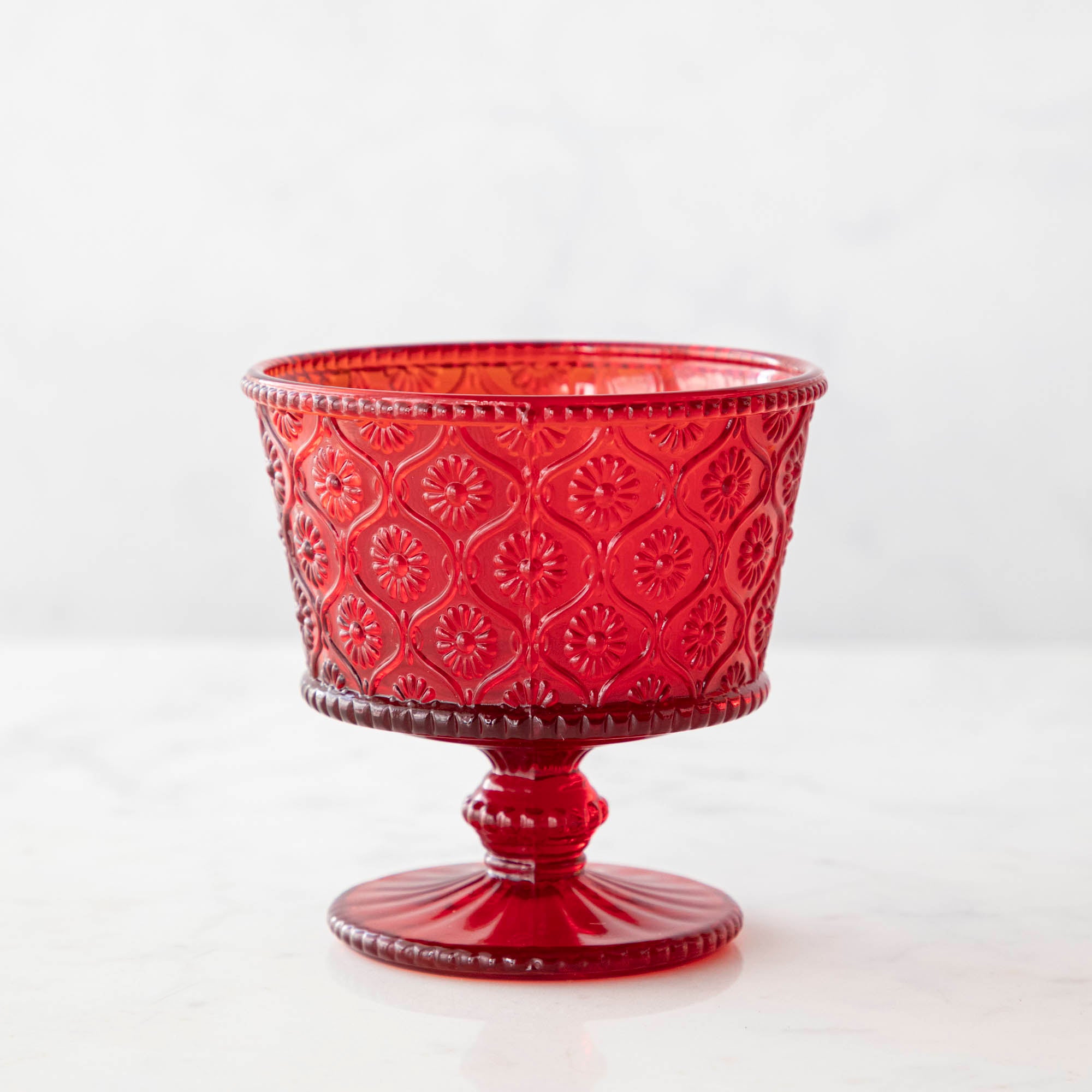 Red Pressed Dessert Bowl on a marble background.
