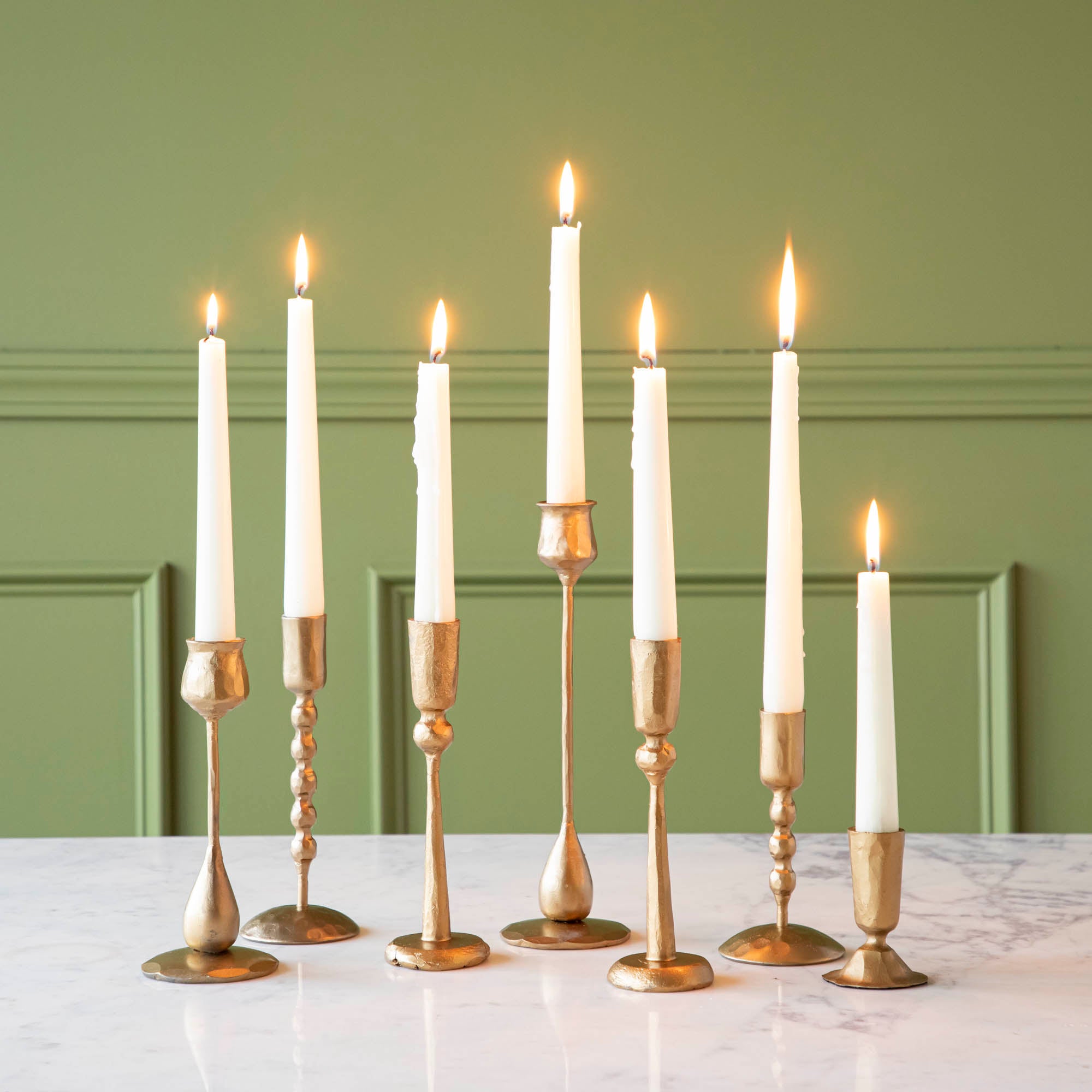 Group of assorted brass candleholders by Creative Co-Op.