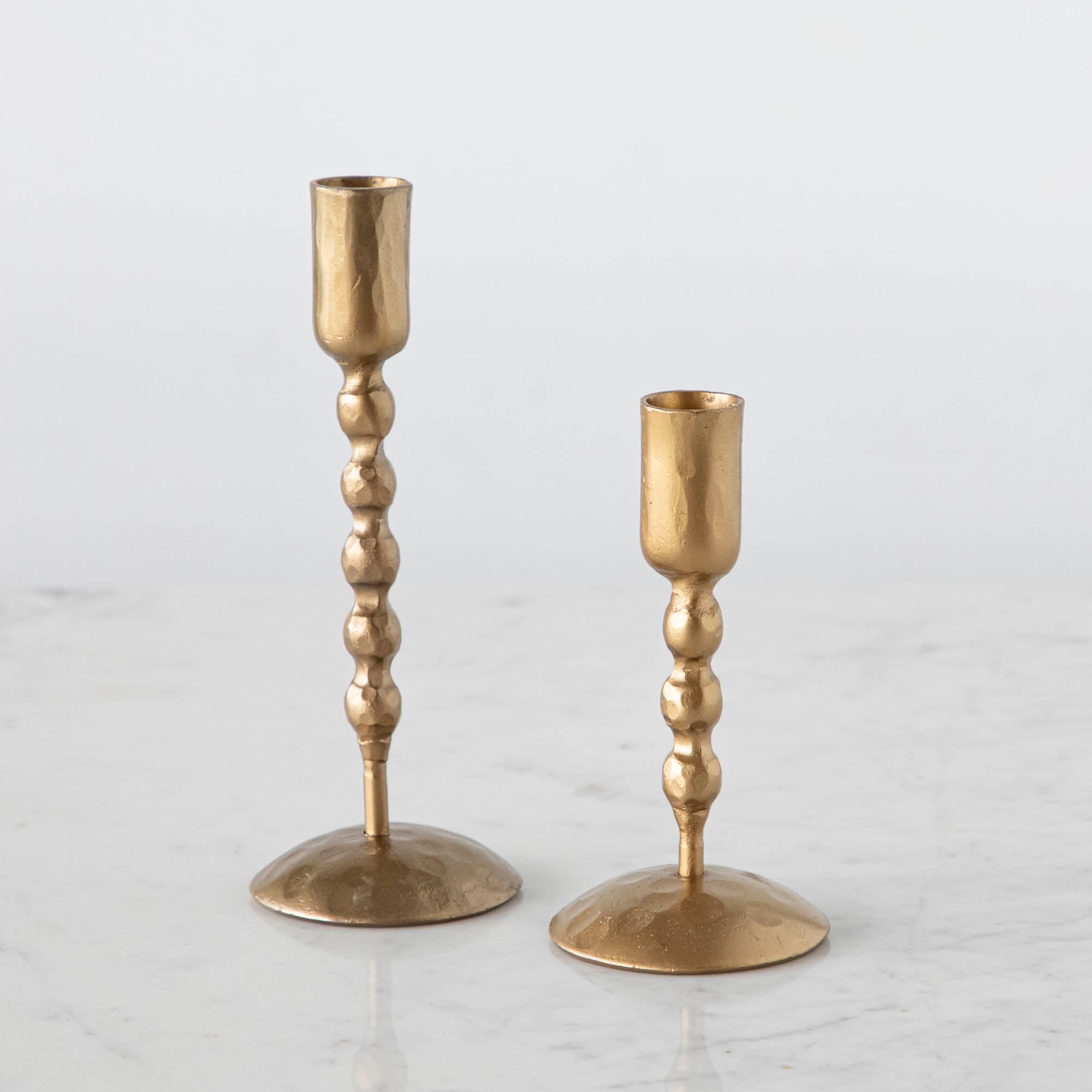 Set of tall and short twisted hand forged candle holders by Creative Co-op.