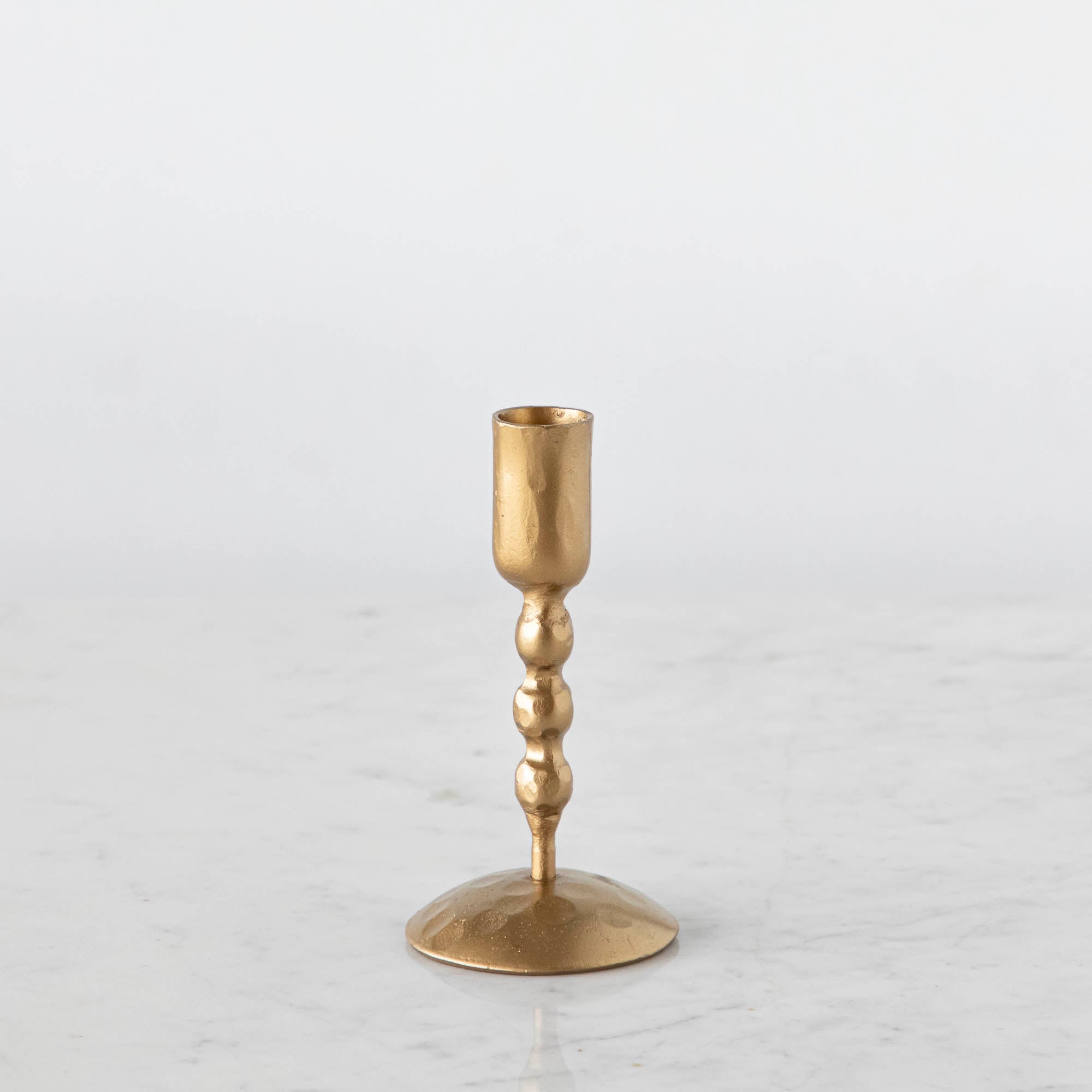 Short gold twisted gold candle holder.