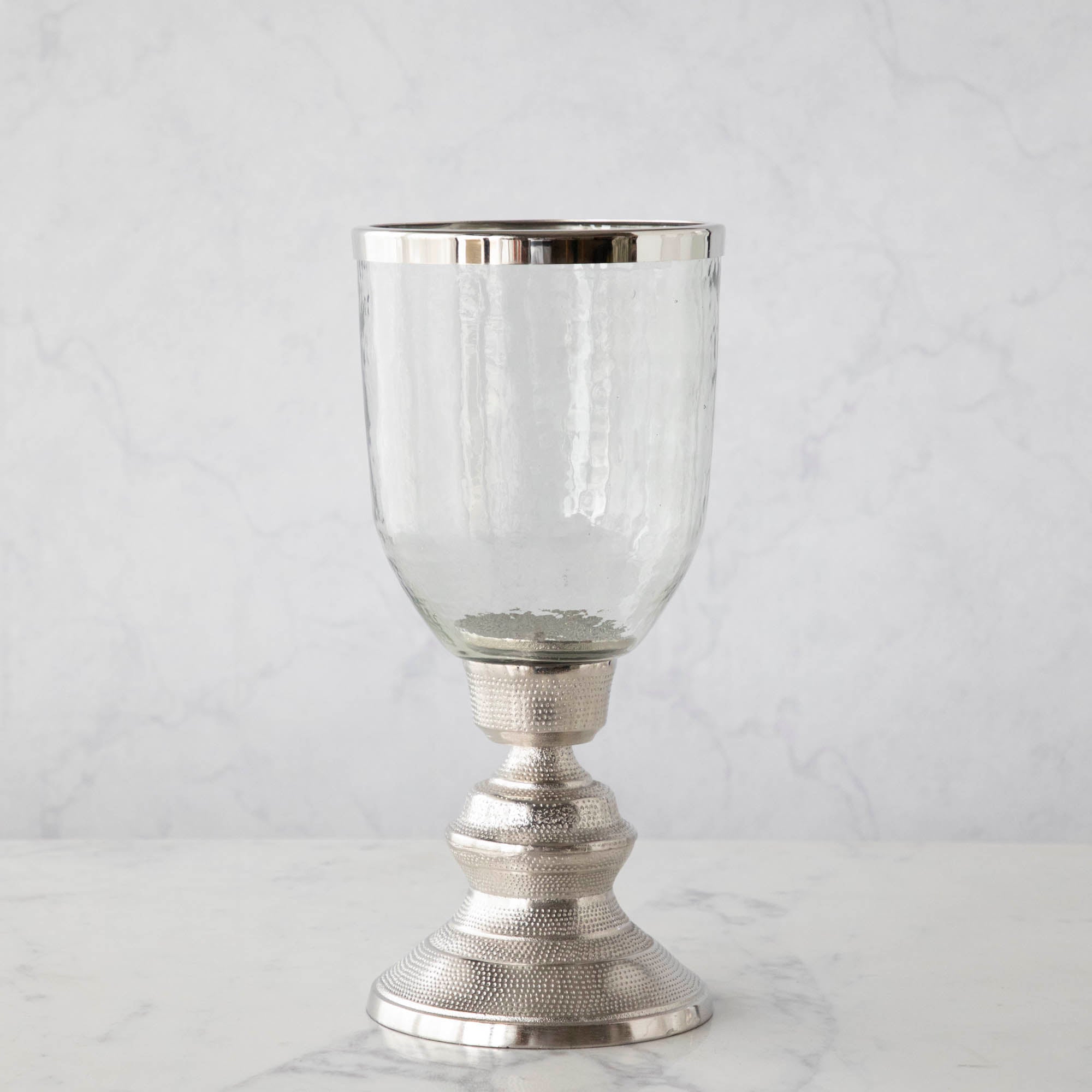 A 14" Candle Hurricane Holder on a marble table.