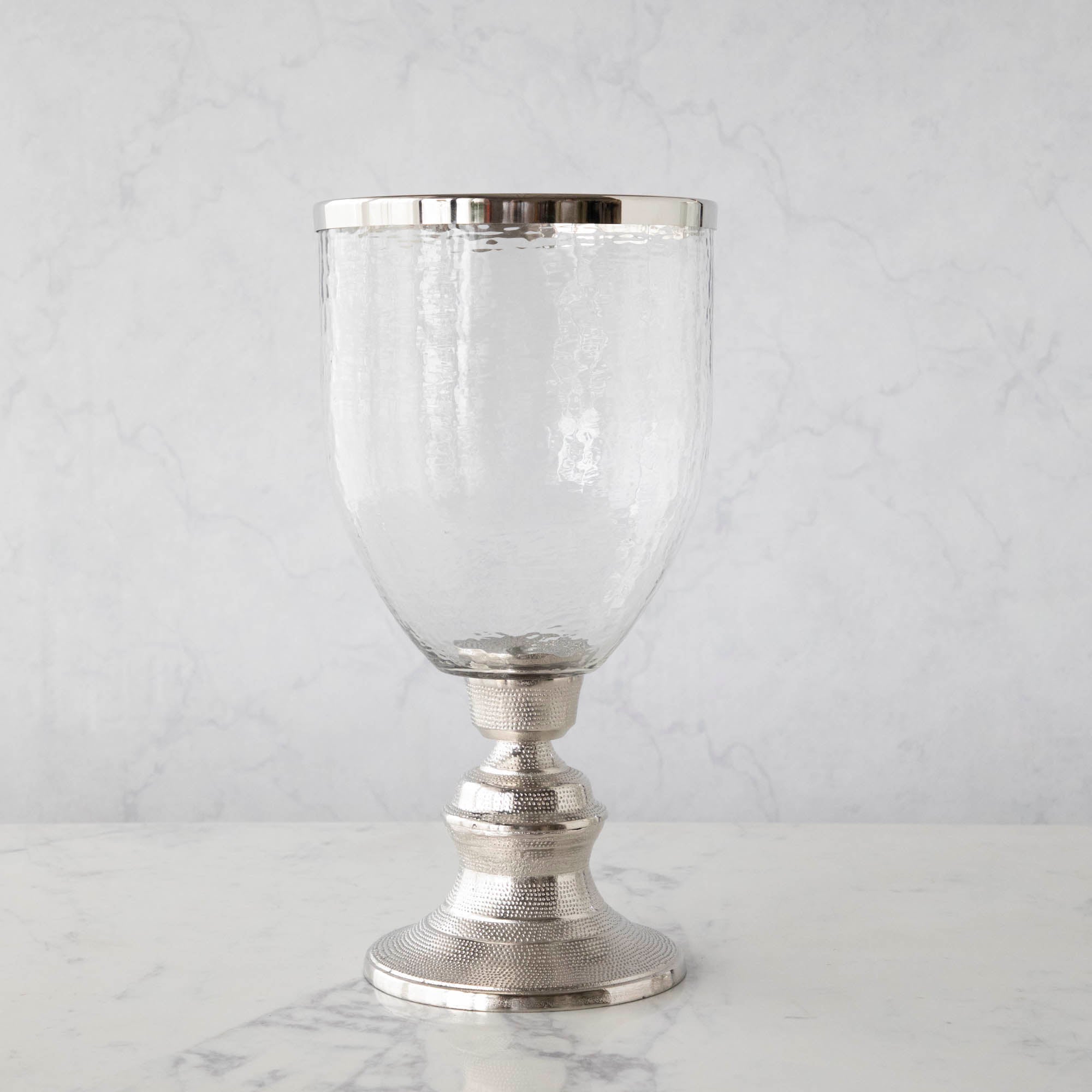 A 17.5" Candle Hurricane Holder on a marble table.