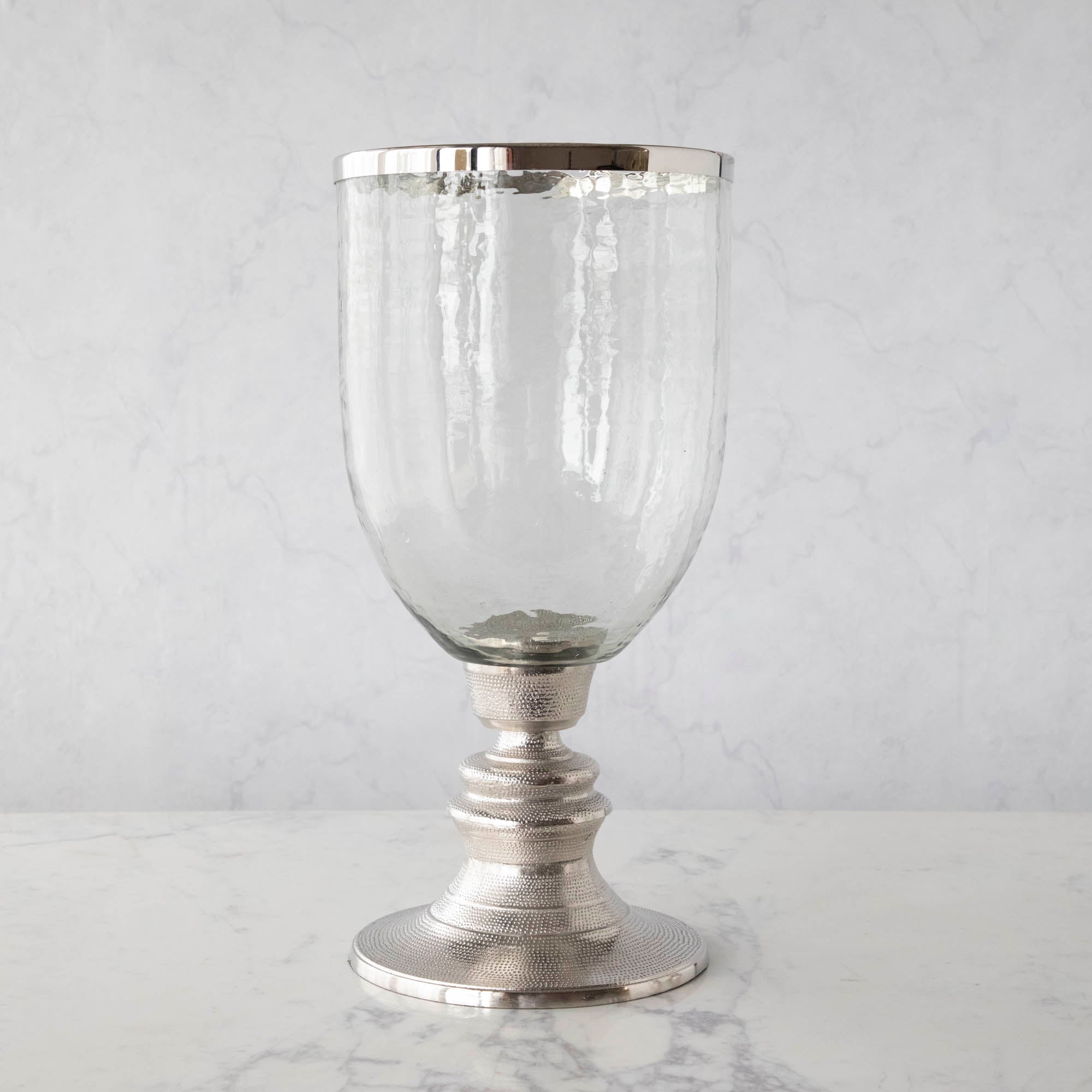 A 12.5" Candle Hurricane Holder on a marble table.