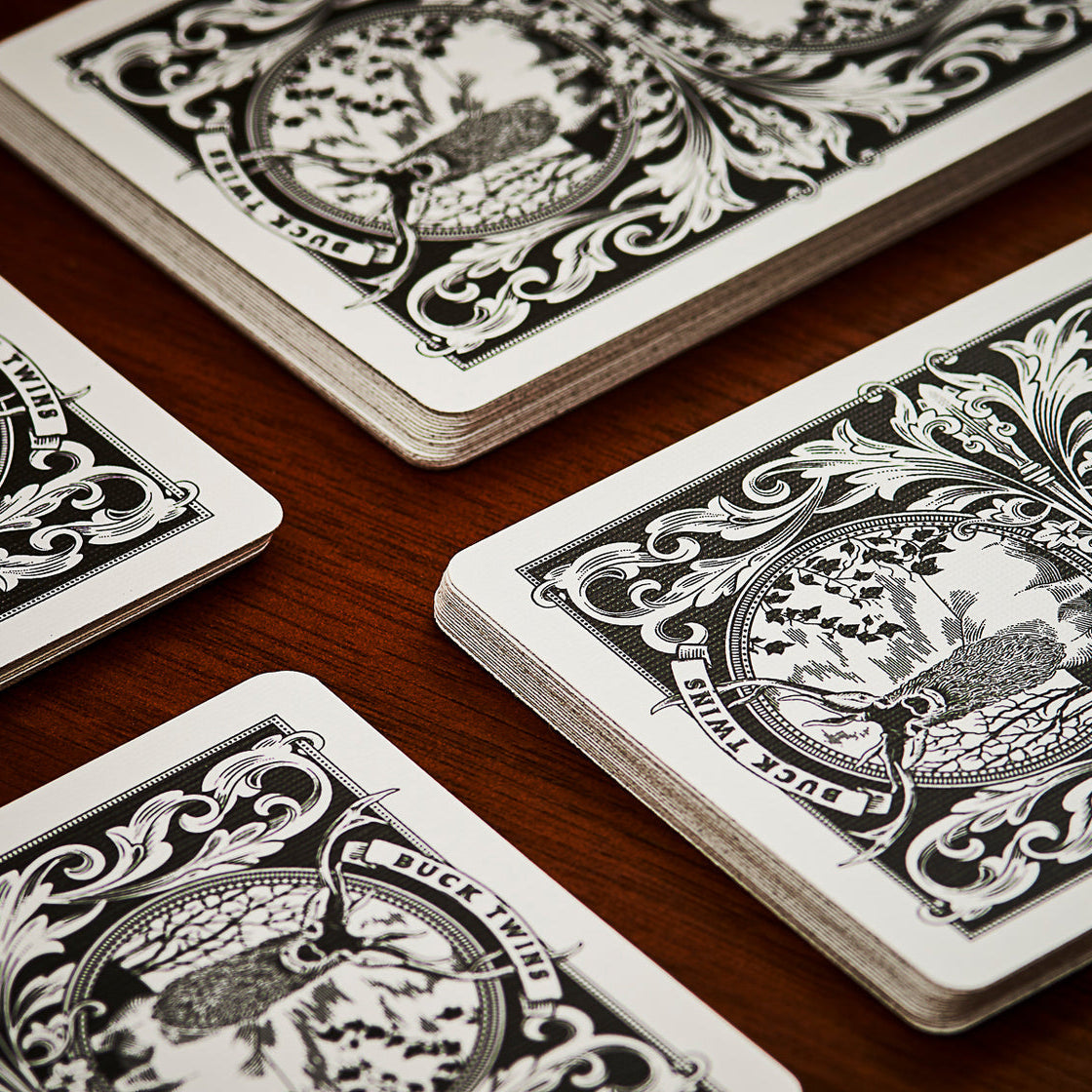 Close-up of ornate playing cards on a wooden surface.