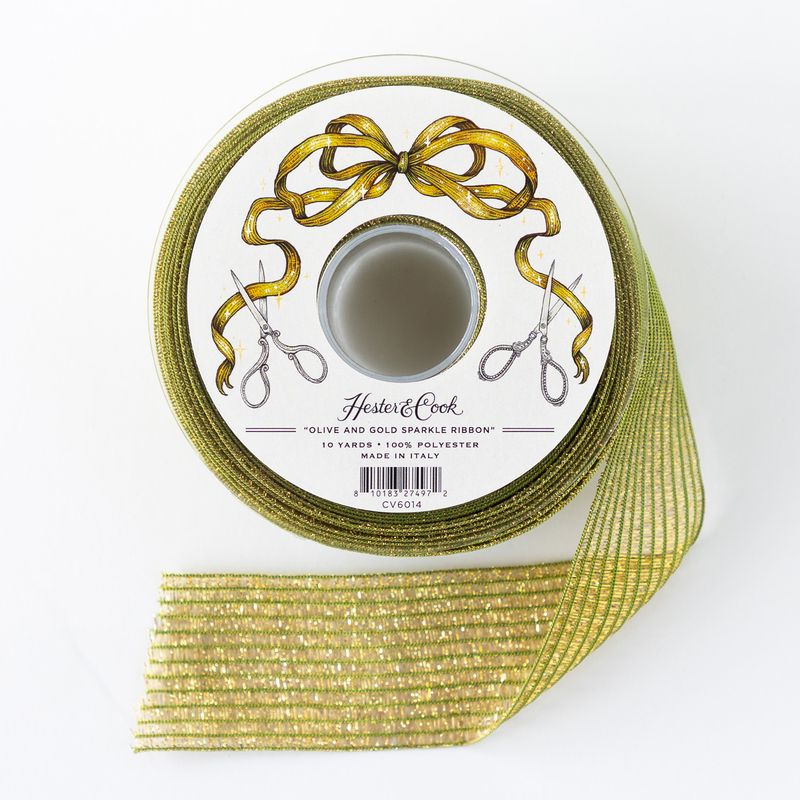 Spool of olive and gold sparkle ribbon with scissors on a white background