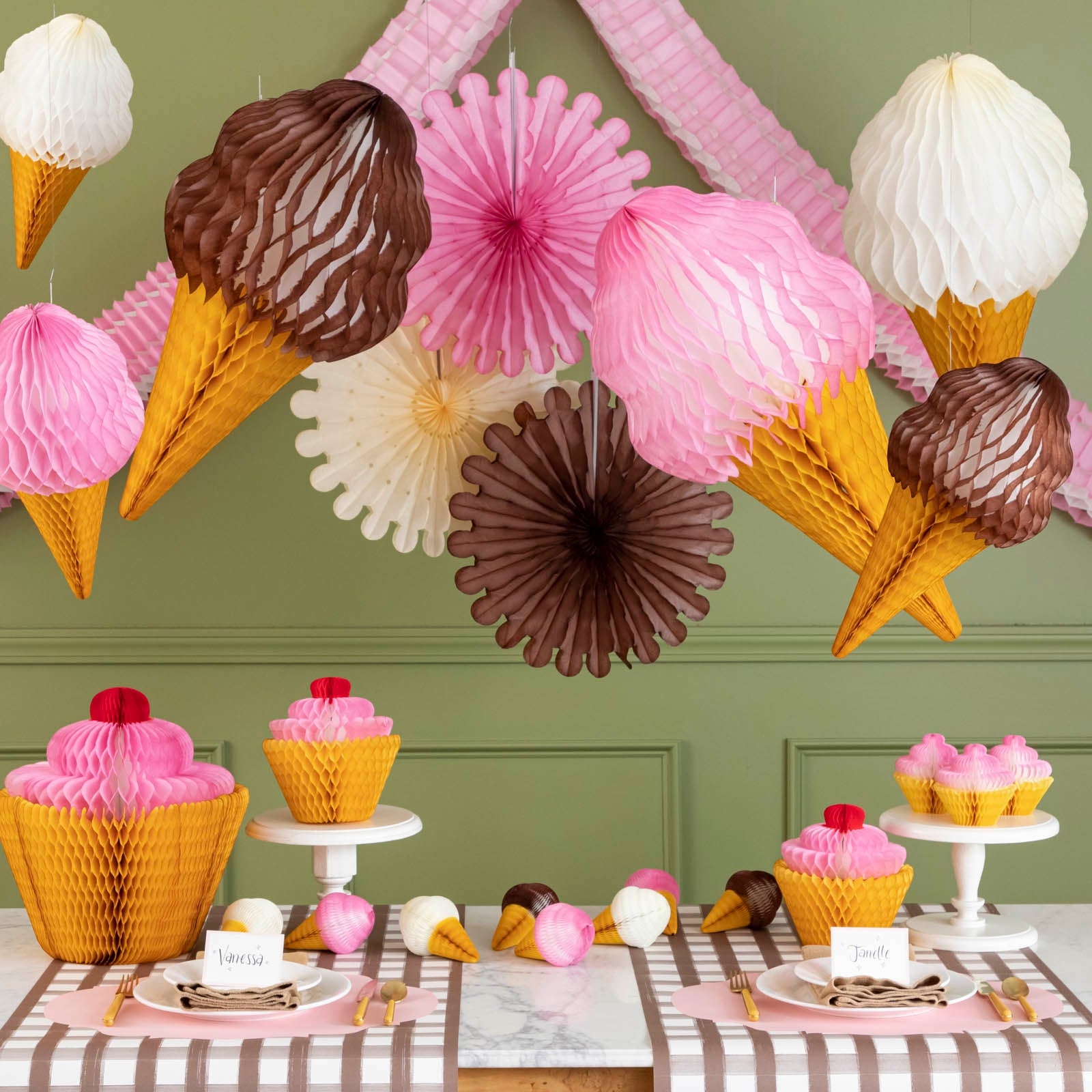 Honeycomb Celebration Fan Set of 3 strung on a wall styled above a sweet themed table setting.
