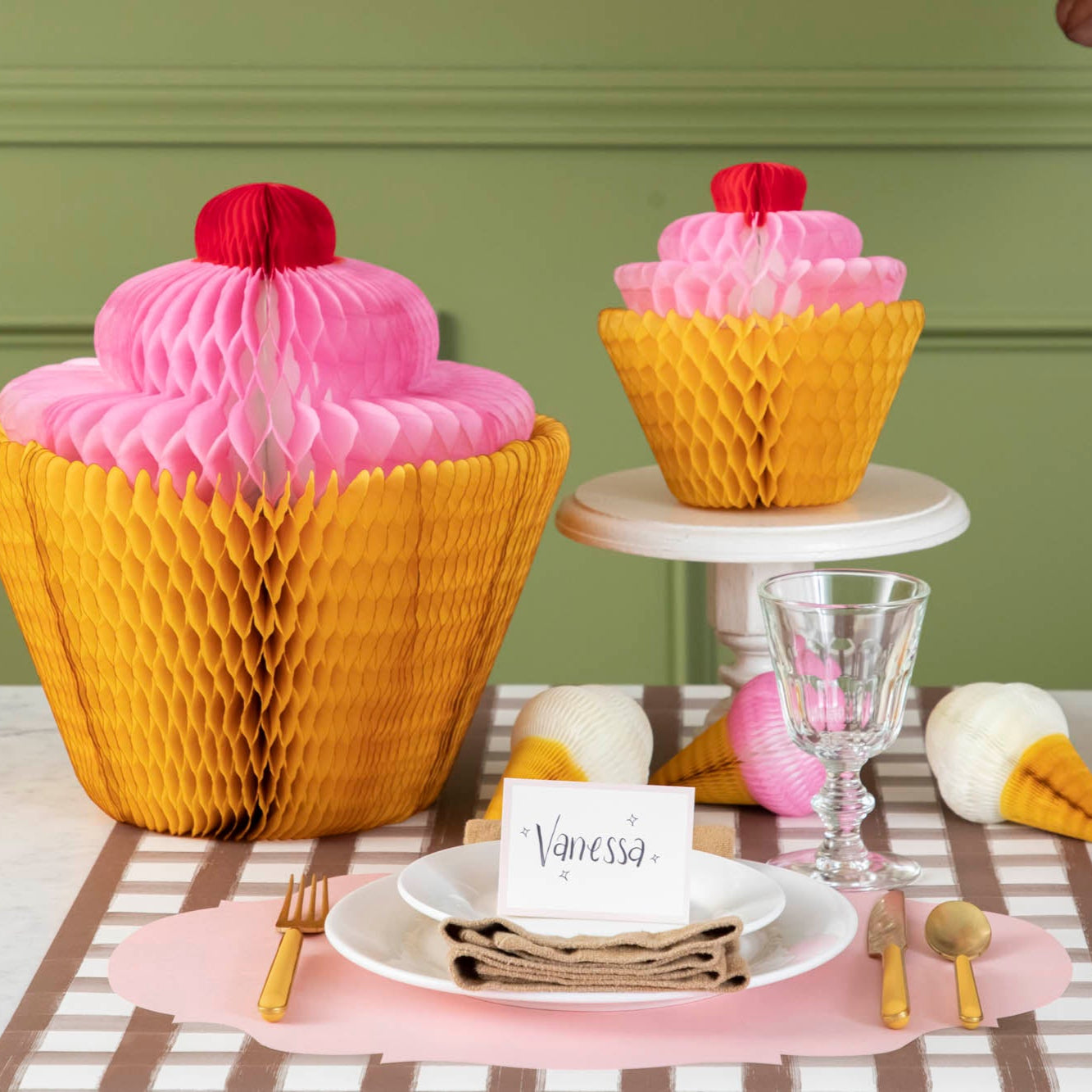 Medium and large Honeycomb Cupcakes styled on a birthday themed table.