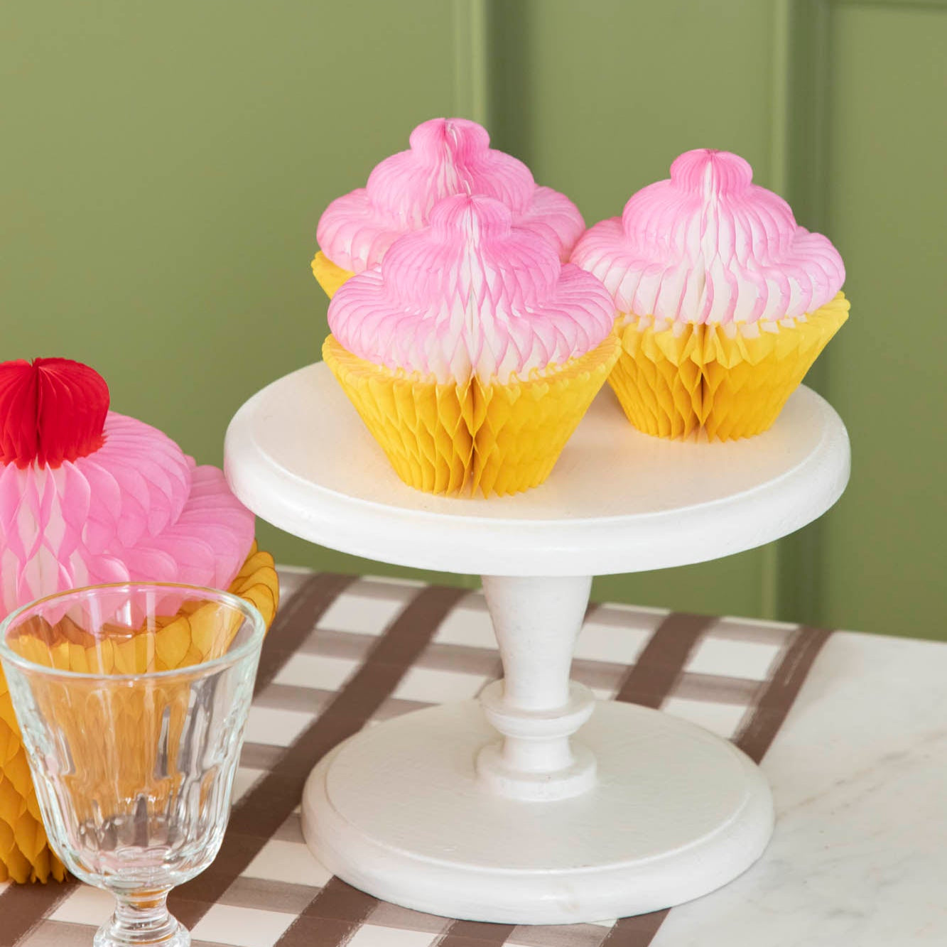 Honeycomb Small Cupcake Set of 3 on a cake pedestal, on a table.