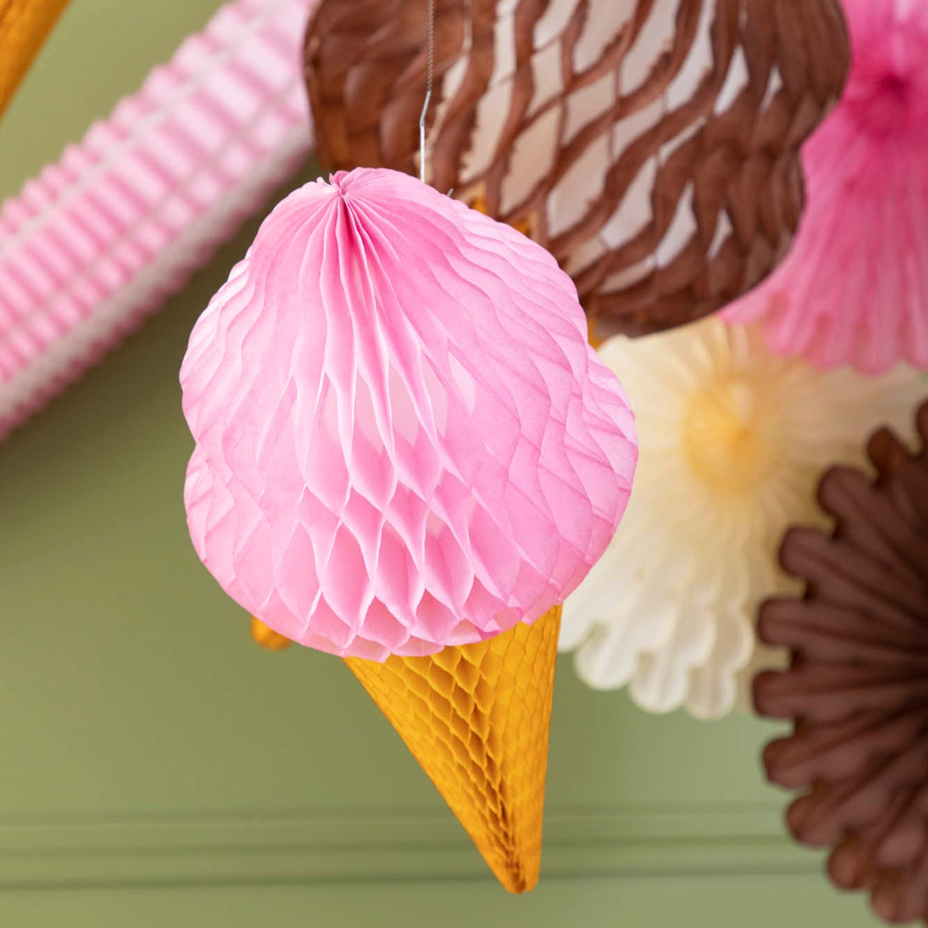 Honeycomb Strawberry Medium Ice Cream Cone hung on a string from the ceiling.