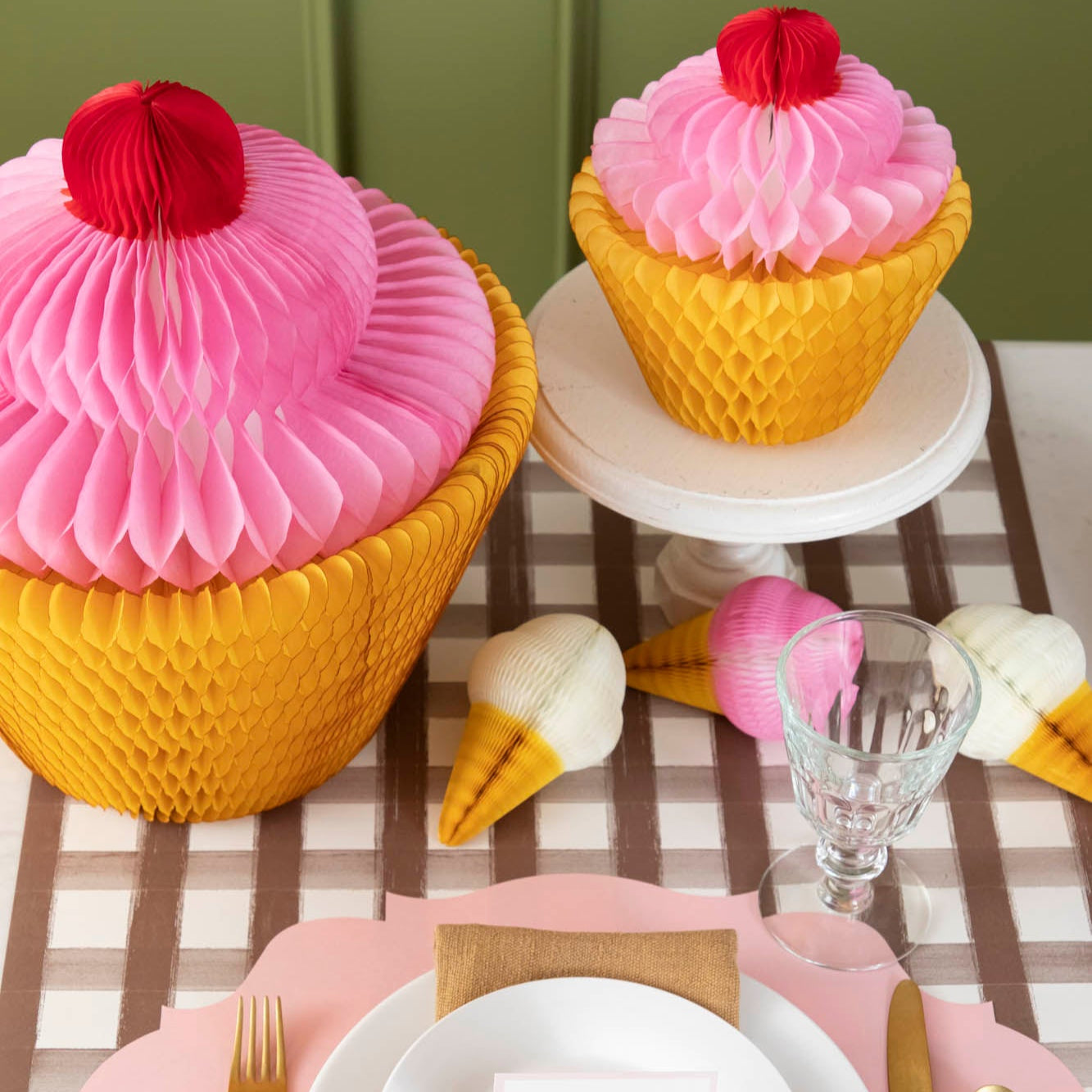 Medium and Large Honeycomb Cupcakes behind a place setting.