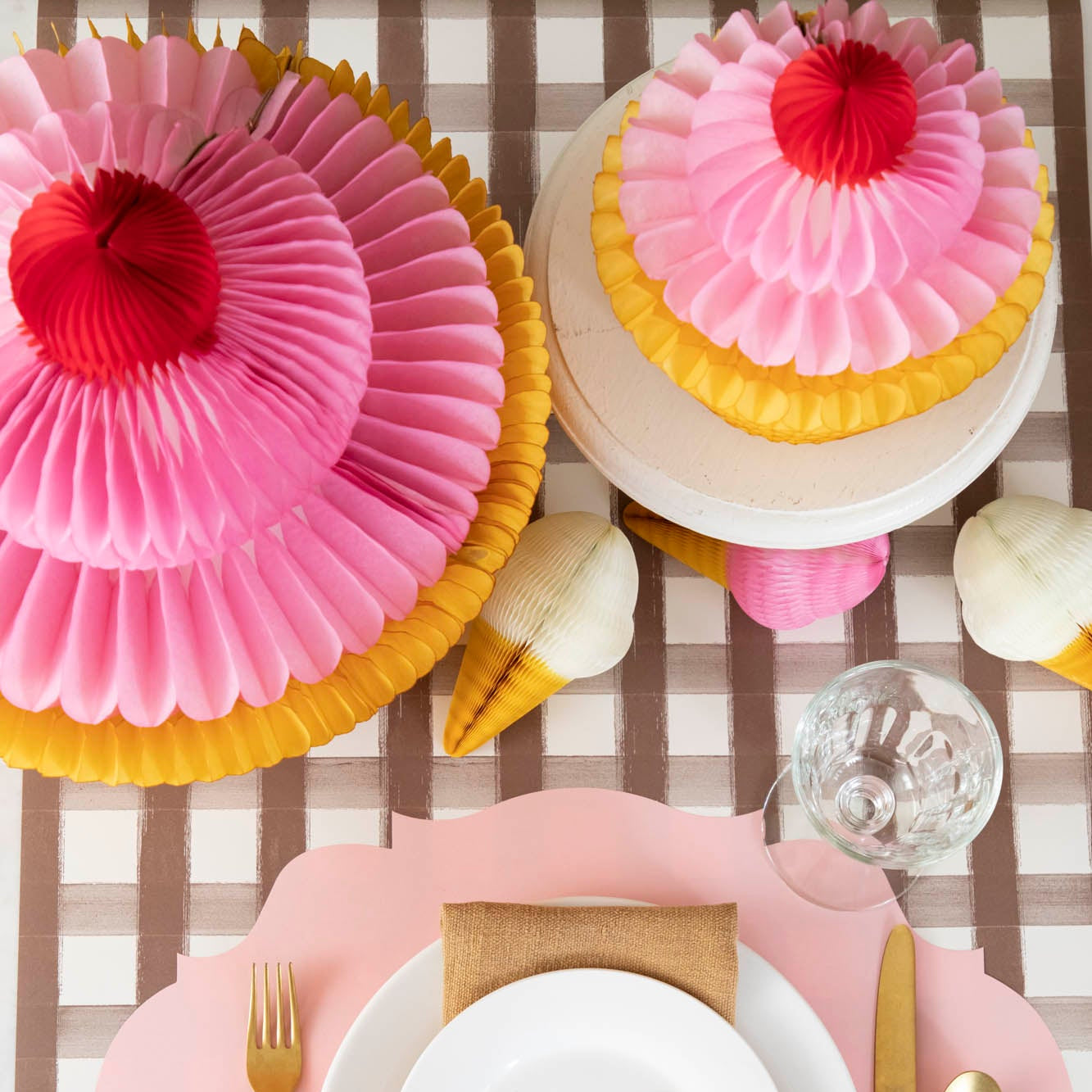 Medium and large Honeycomb Cupcakes behind a place setting for one.