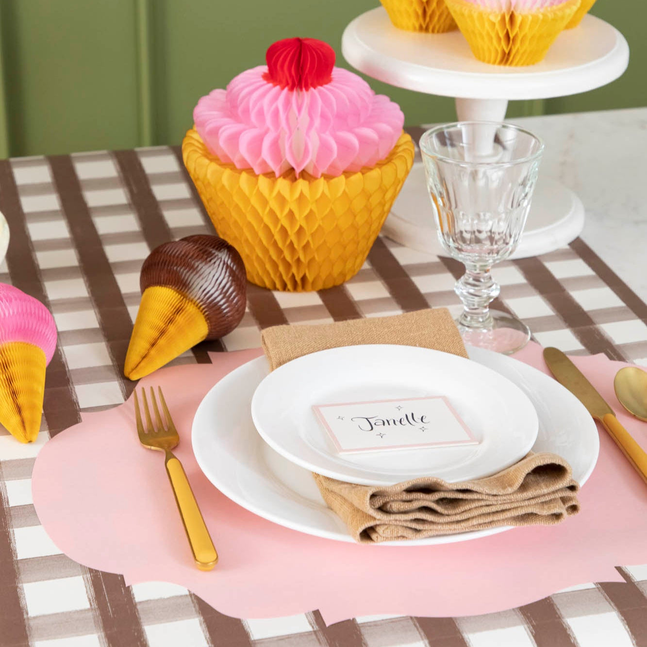 Honeycomb Small Ice Cream Cone in chocolate and strawberry, behind a place setting for one.