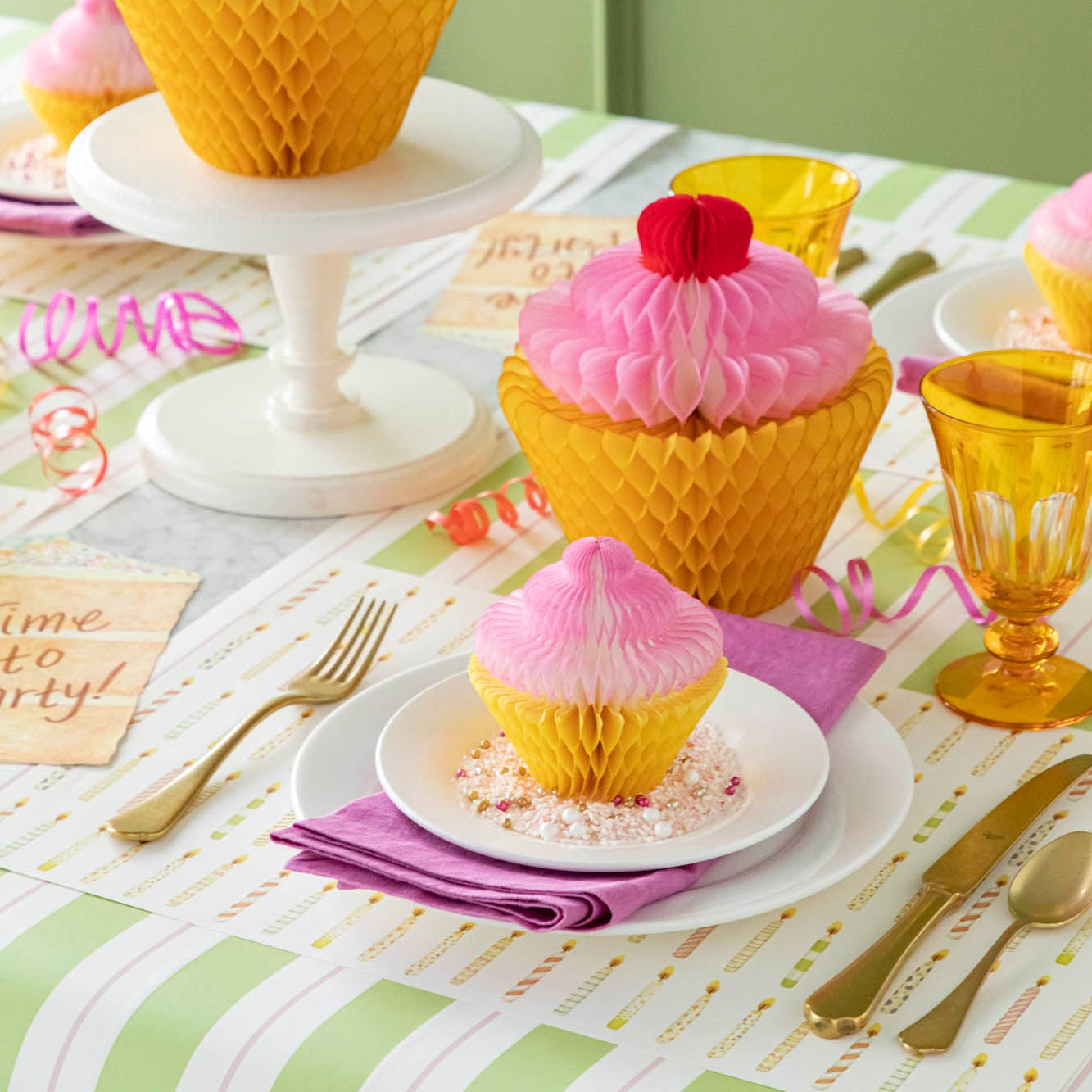 Honeycomb Medium Cupcake on top of dinner plates, styled on a fun, birthday themed table setting.