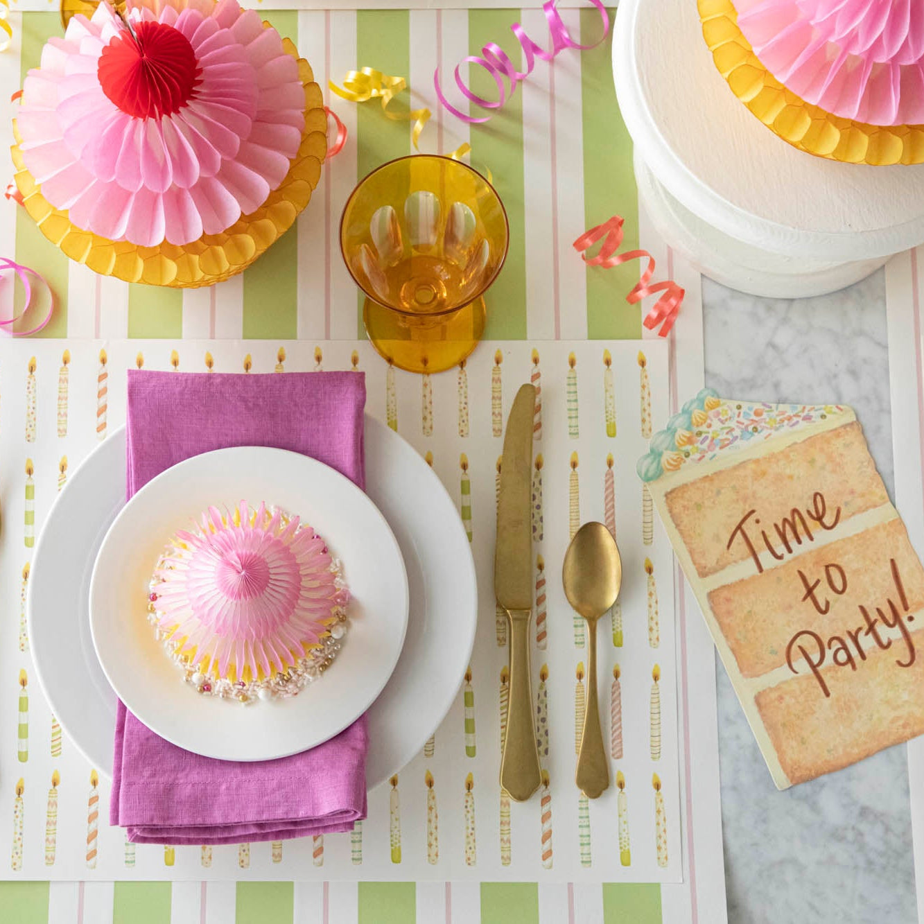 Honeycomb Medium Cupcake on top of dinner plates, styled on a fun, birthday themed table setting.