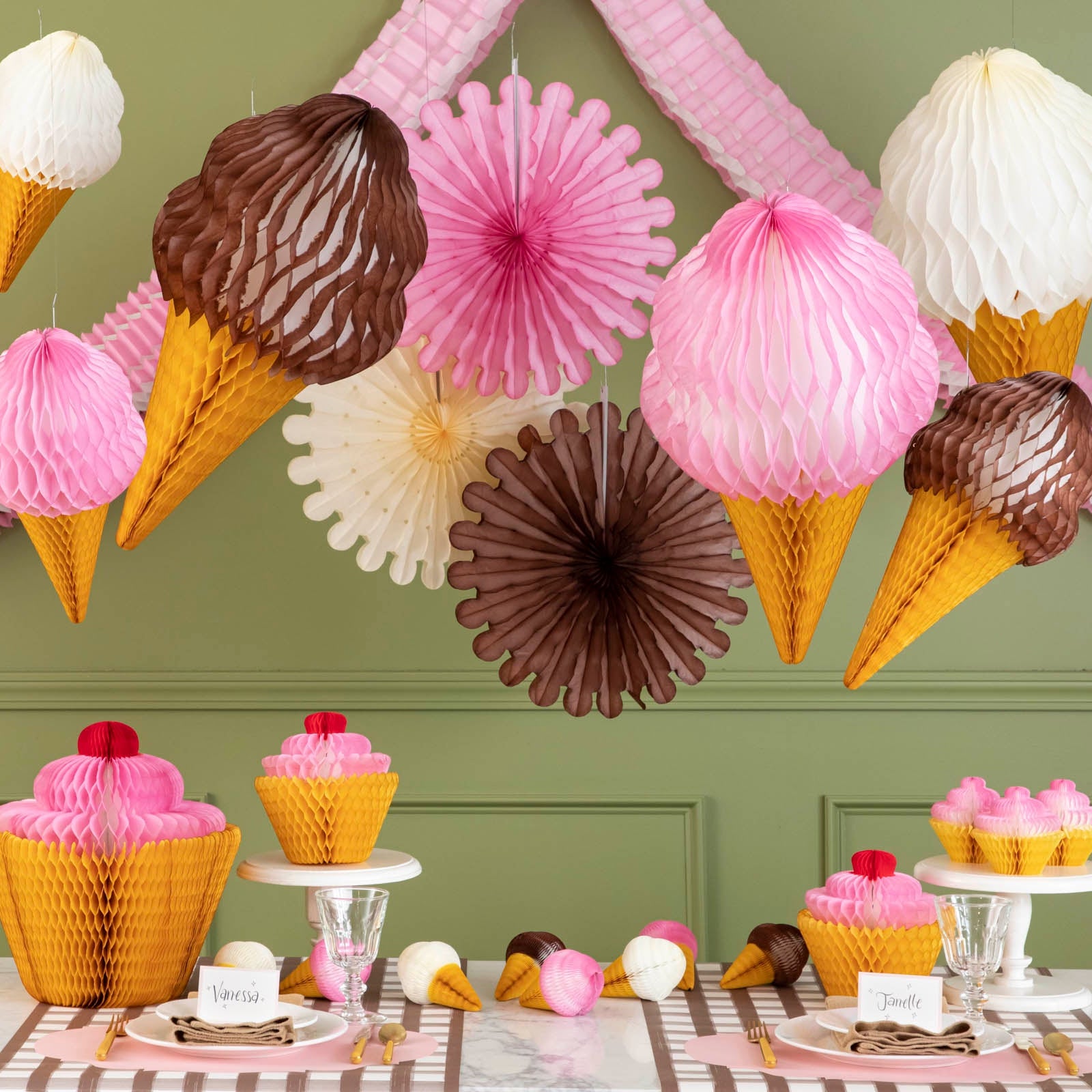 Large Honeycomb Ice Cream hung from the ceiling above a birthday themed table setting.