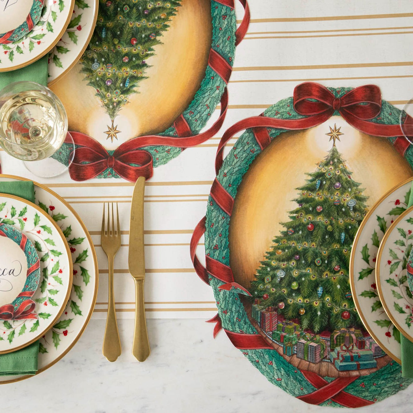 Die-cut O Christmas Tree Wreath Placemat with holly themed dinner plates fancy table setting.