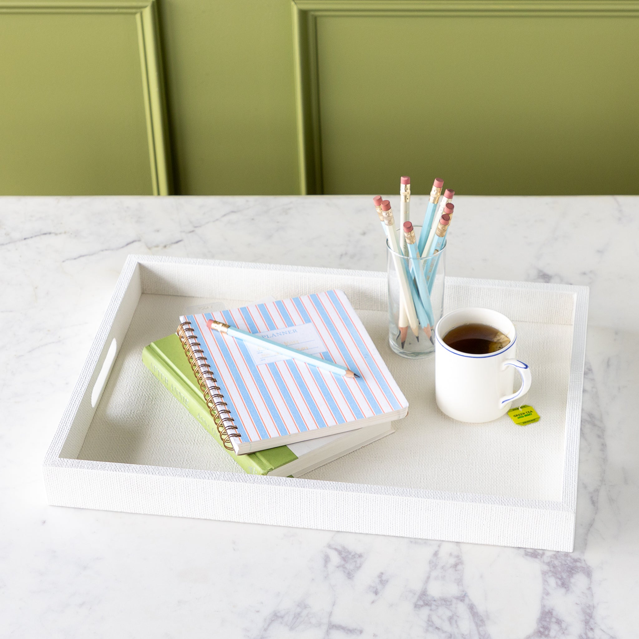 Silk Linen St. Tropez Decorative Tray with a book, planner, cup of tea and cup of pencils atop.