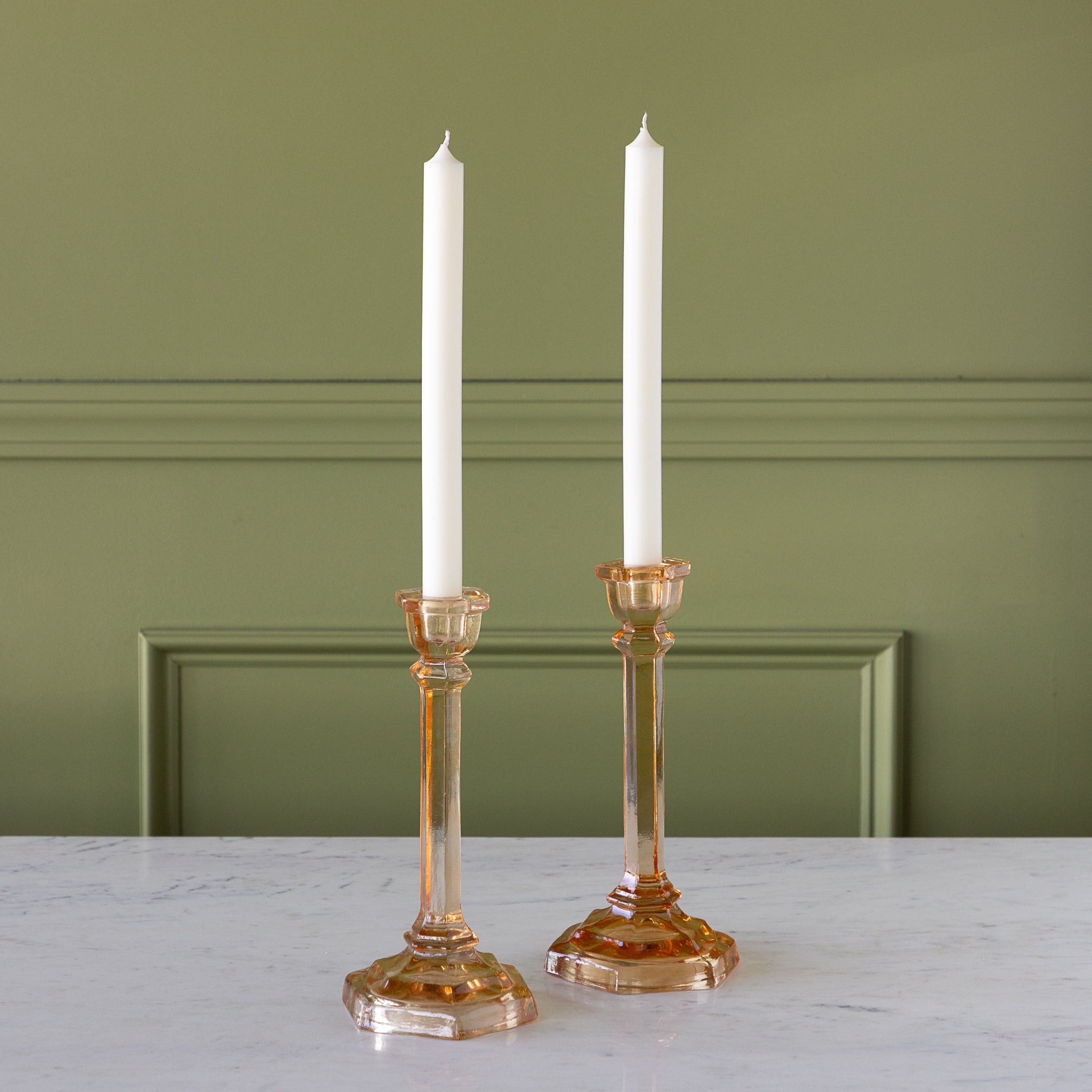 Amber Glass Taper Holders with candles in them.