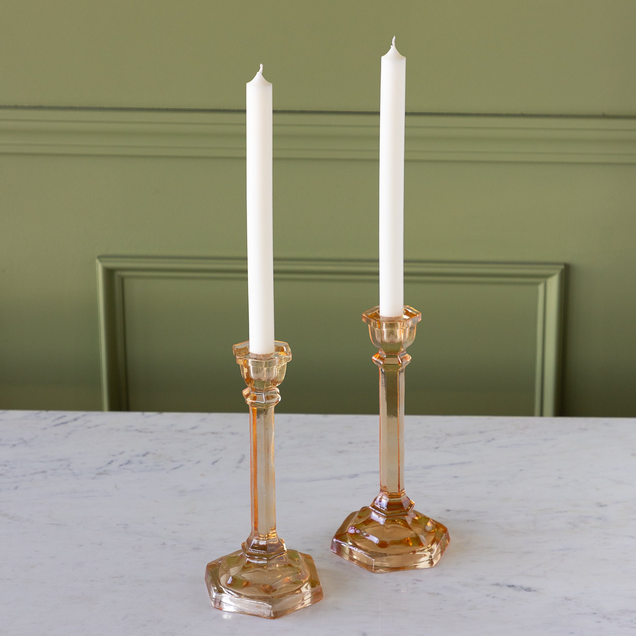 Amber Glass Taper Holders with candles in them.