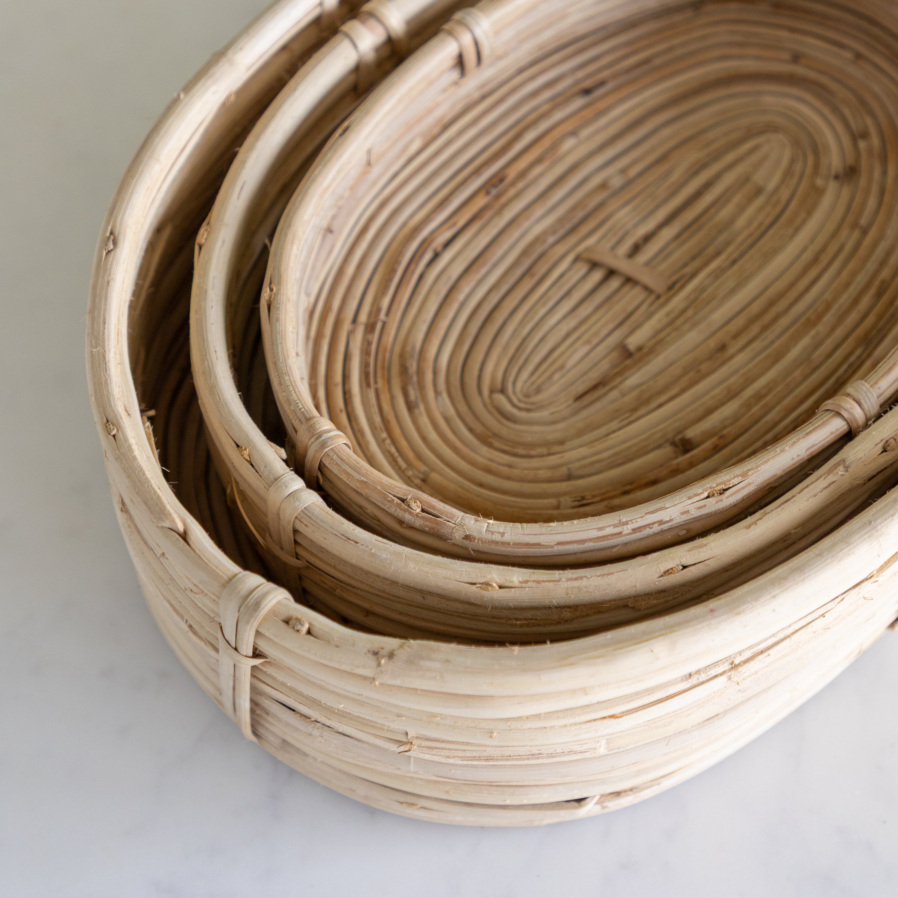 Stack of woven baskets on a light background