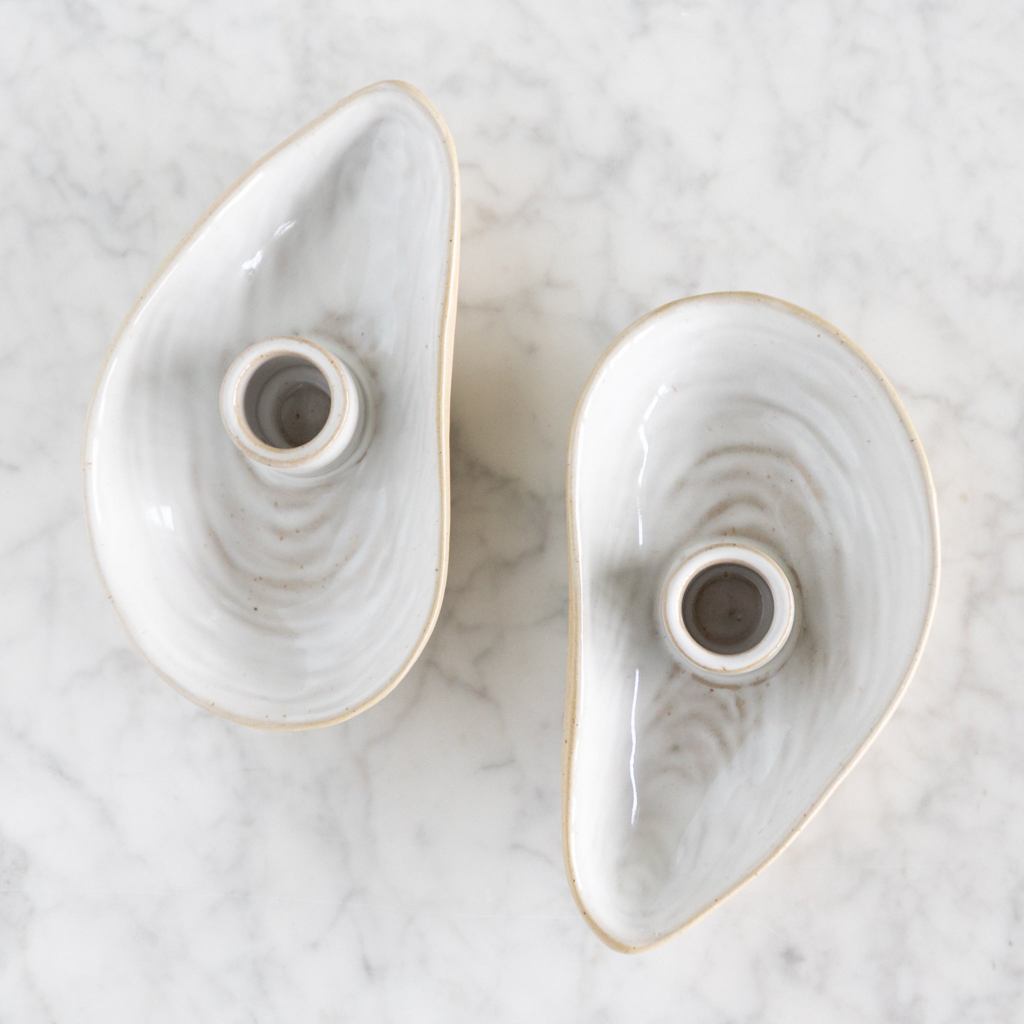 Two Oyster Shell candle holders.