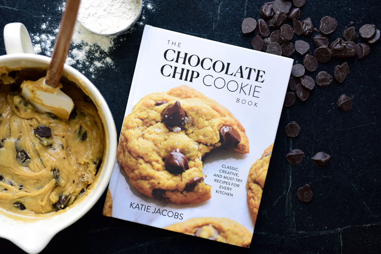 Chocolate Chip Cookie Book next to a mixing bowl with batter in it.