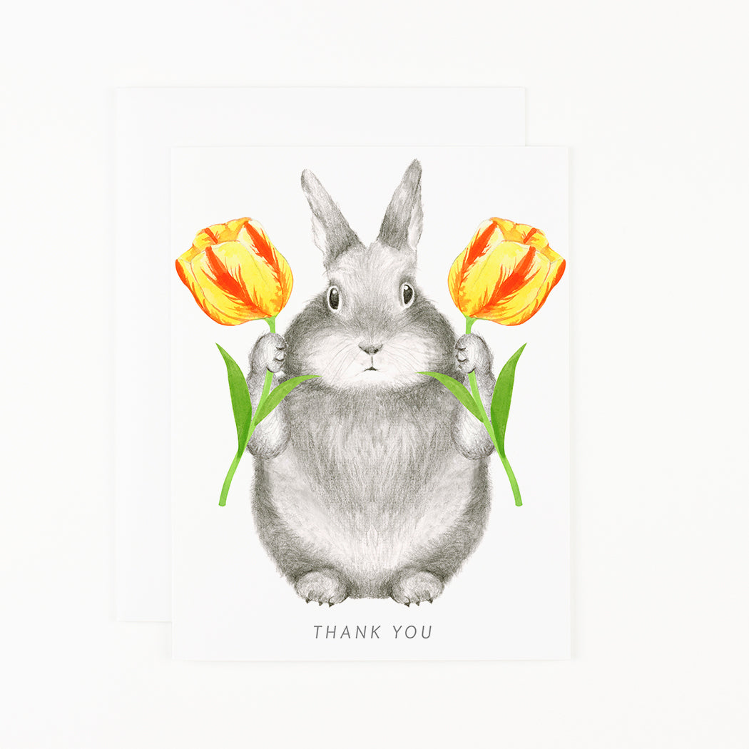 A Bunny with Tulips Card by Dear Hancock, featuring a bunny holding tulips, with a blank interior for your personal message.