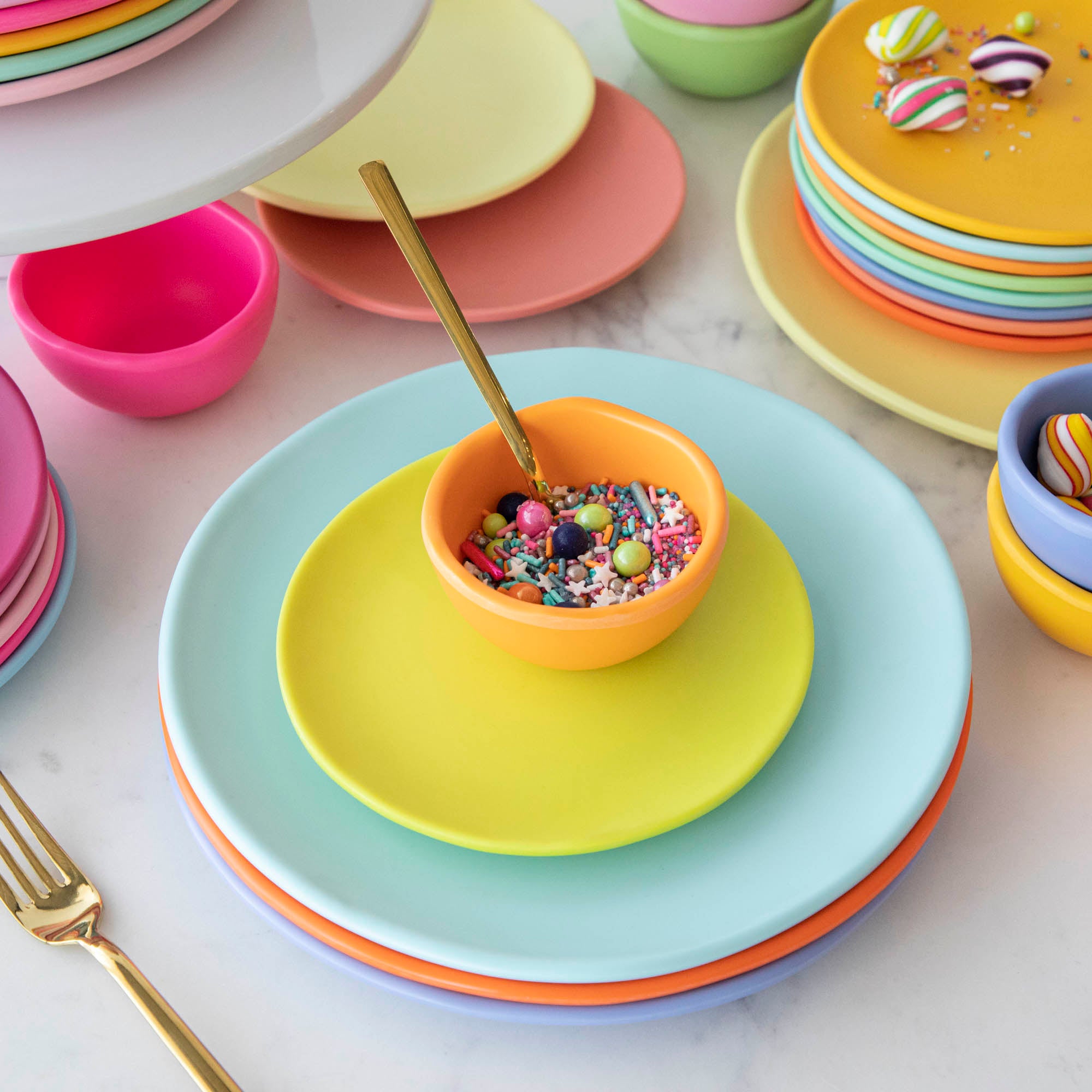 A set of colorful, dishwasher-safe Glitterville Rainbow Melamine Trinket Bowls on a table.