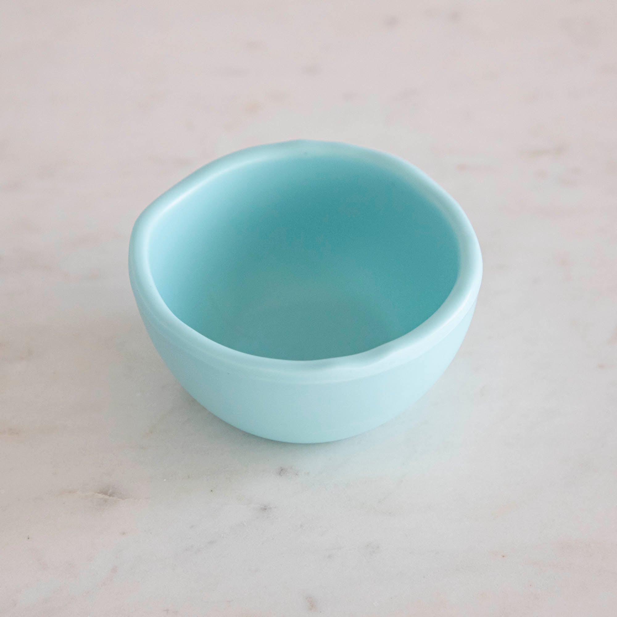 A set of colorful, dishwasher-safe Glitterville Rainbow Melamine Trinket Bowls on a table.