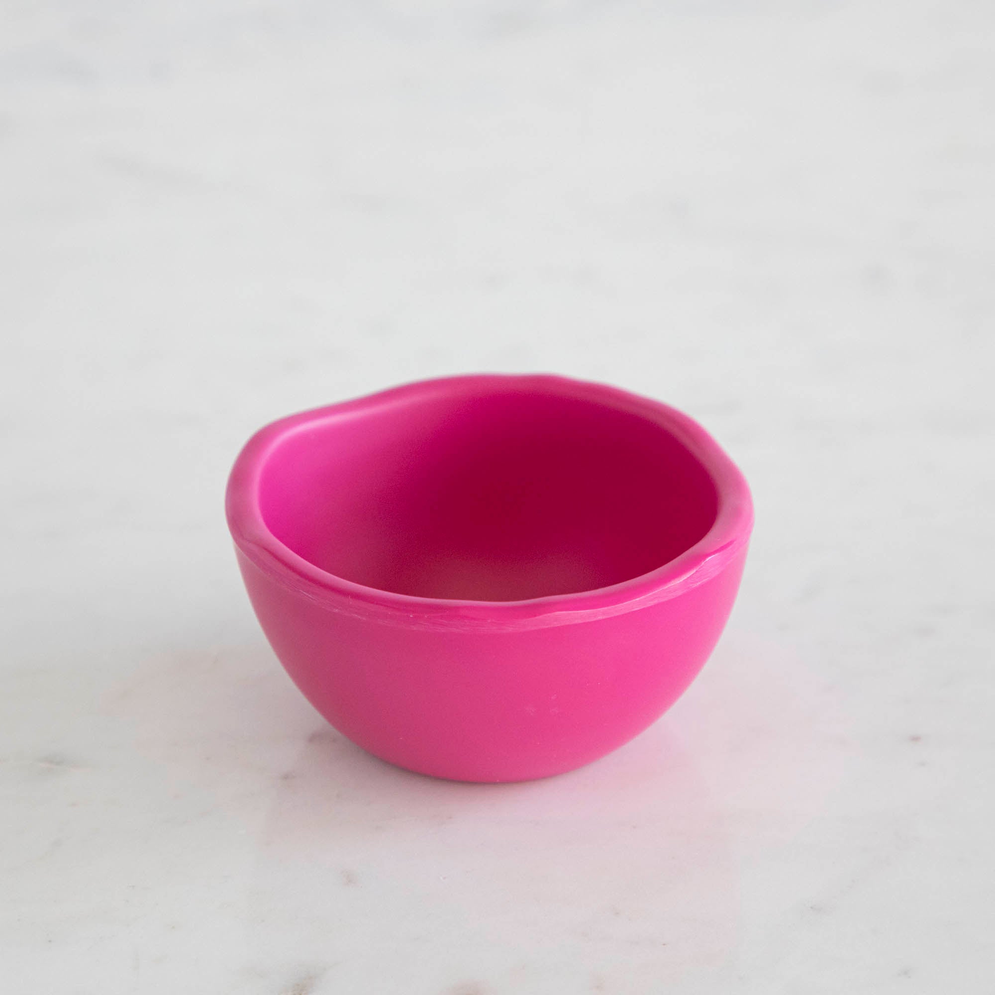 A set of colorful, dishwasher-safe Glitterville Rainbow Melamine Trinket Bowls on a table.