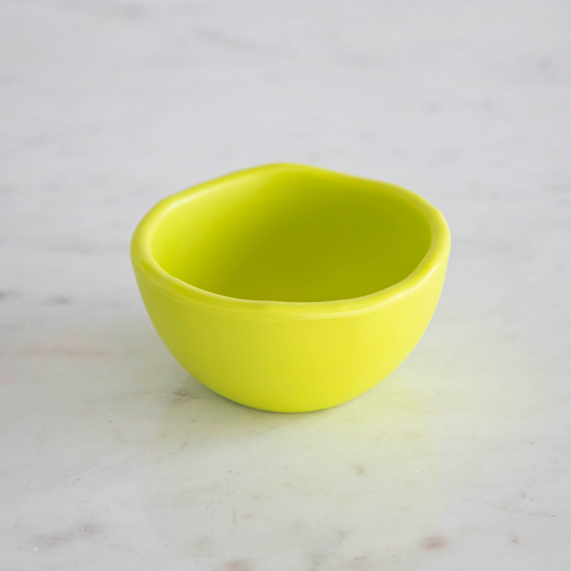 A set of colorful, dishwasher-safe Glitterville Rainbow Melamine Trinket Bowls on a table.