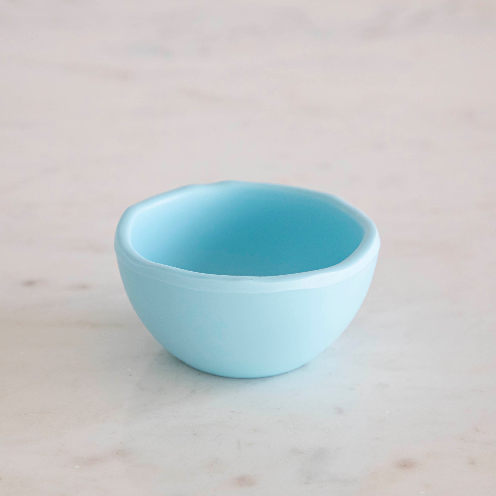 A set of colorful, dishwasher-safe Glitterville Rainbow Melamine Trinket Bowls on a table.