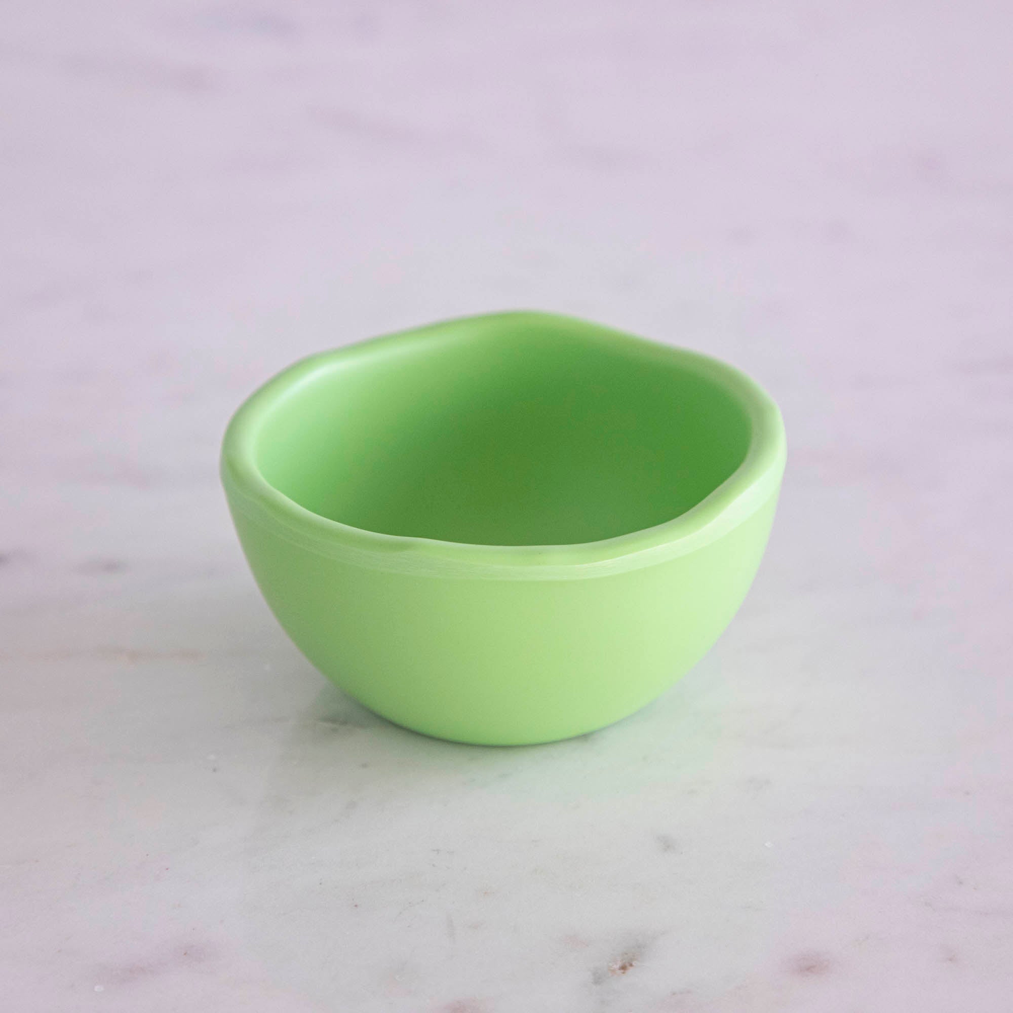 A set of colorful, dishwasher-safe Glitterville Rainbow Melamine Trinket Bowls on a table.