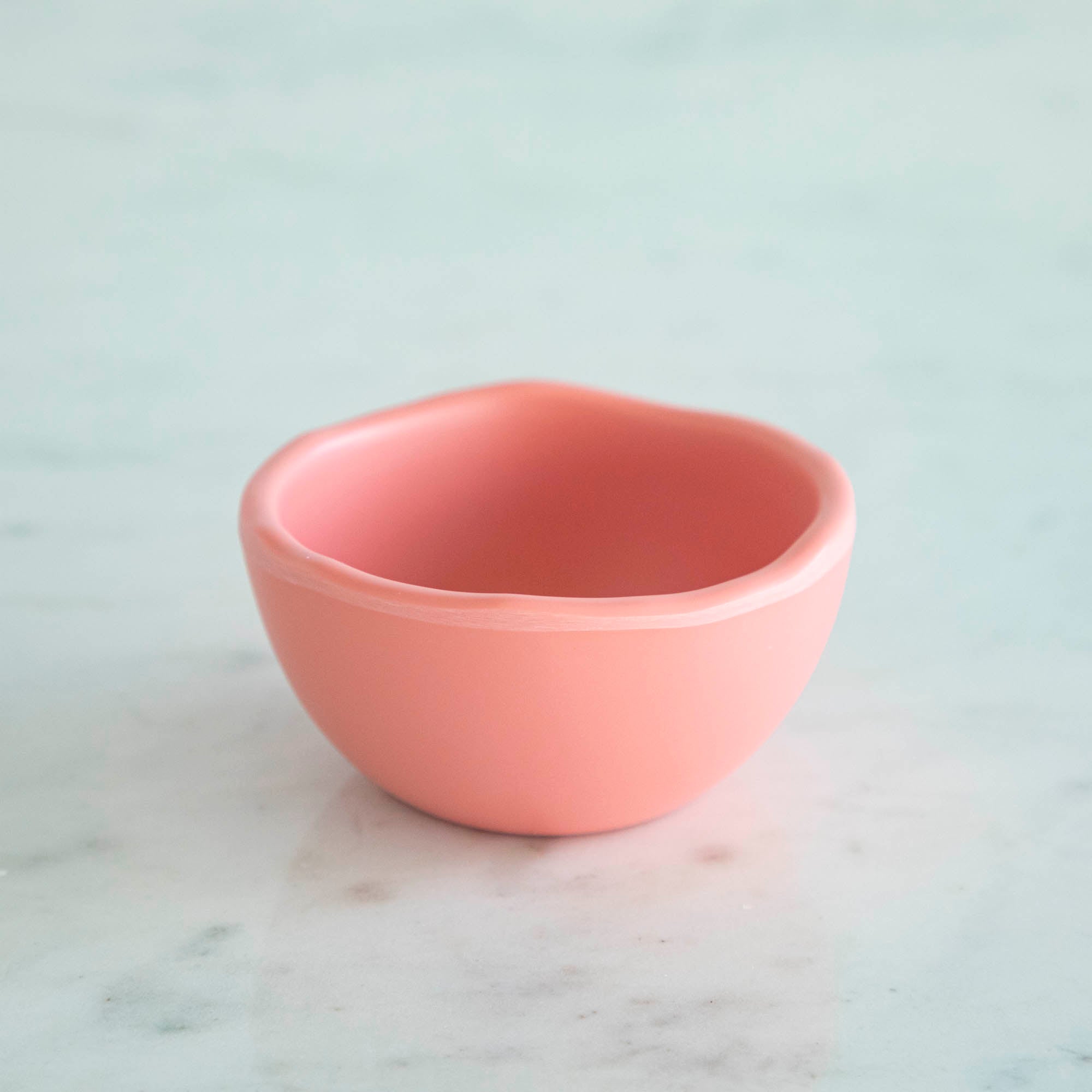 A set of colorful, dishwasher-safe Glitterville Rainbow Melamine Trinket Bowls on a table.