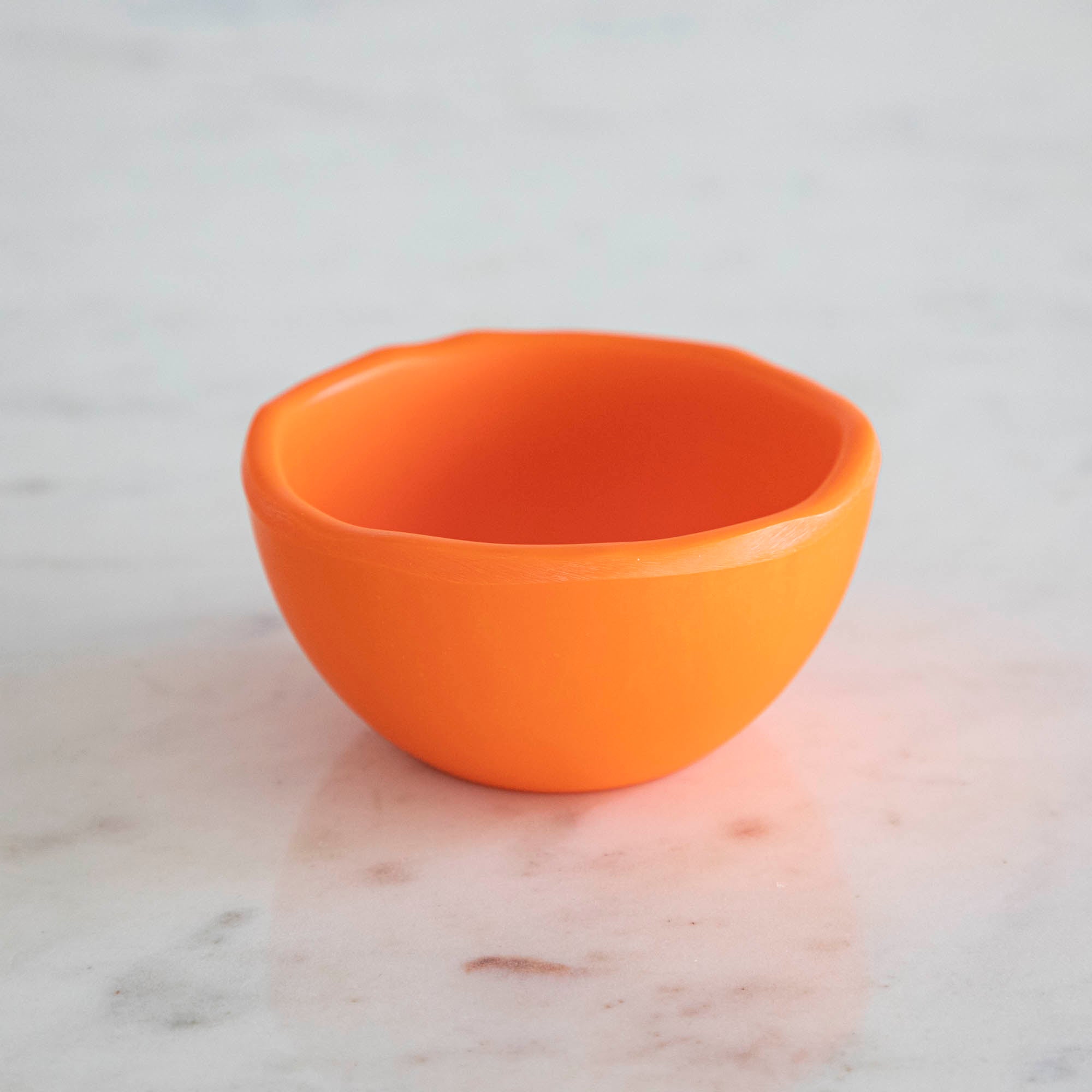 A set of colorful, dishwasher-safe Glitterville Rainbow Melamine Trinket Bowls on a table.