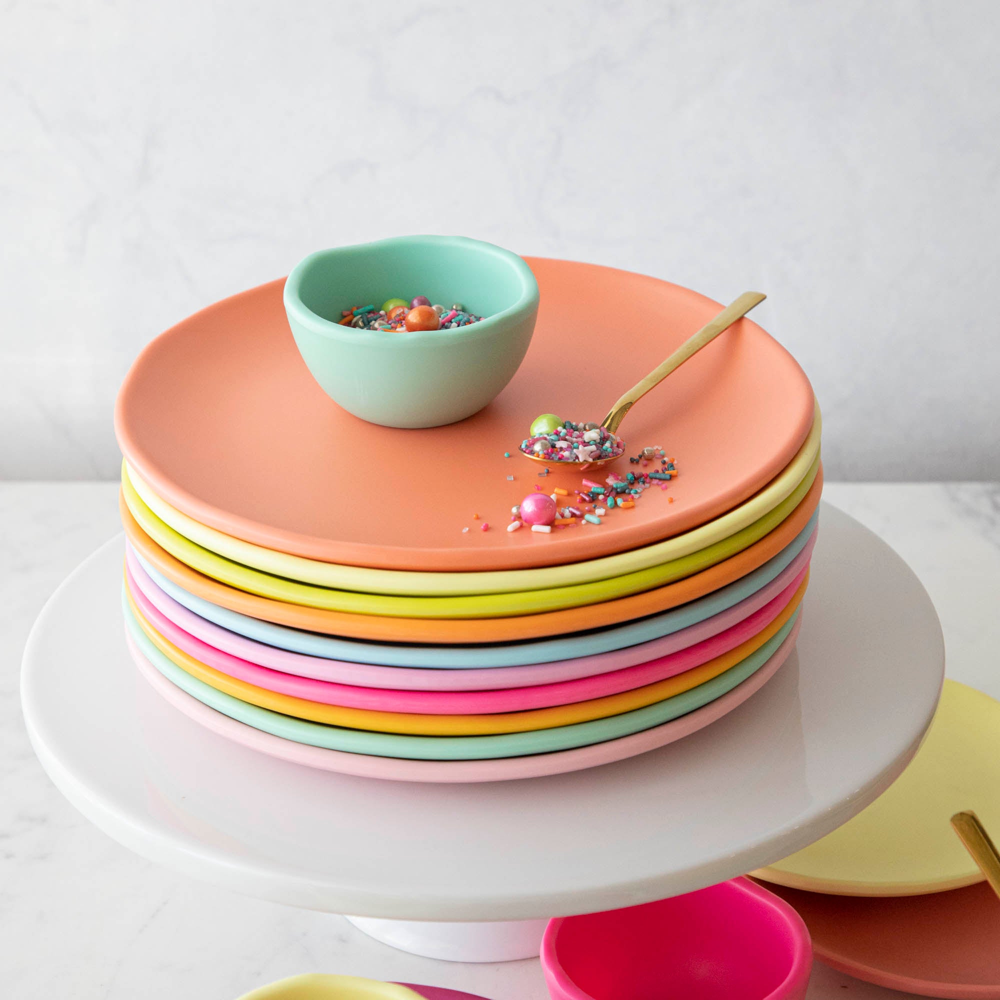 A set of colorful, dishwasher-safe Glitterville Rainbow Melamine Trinket Bowls on a table.