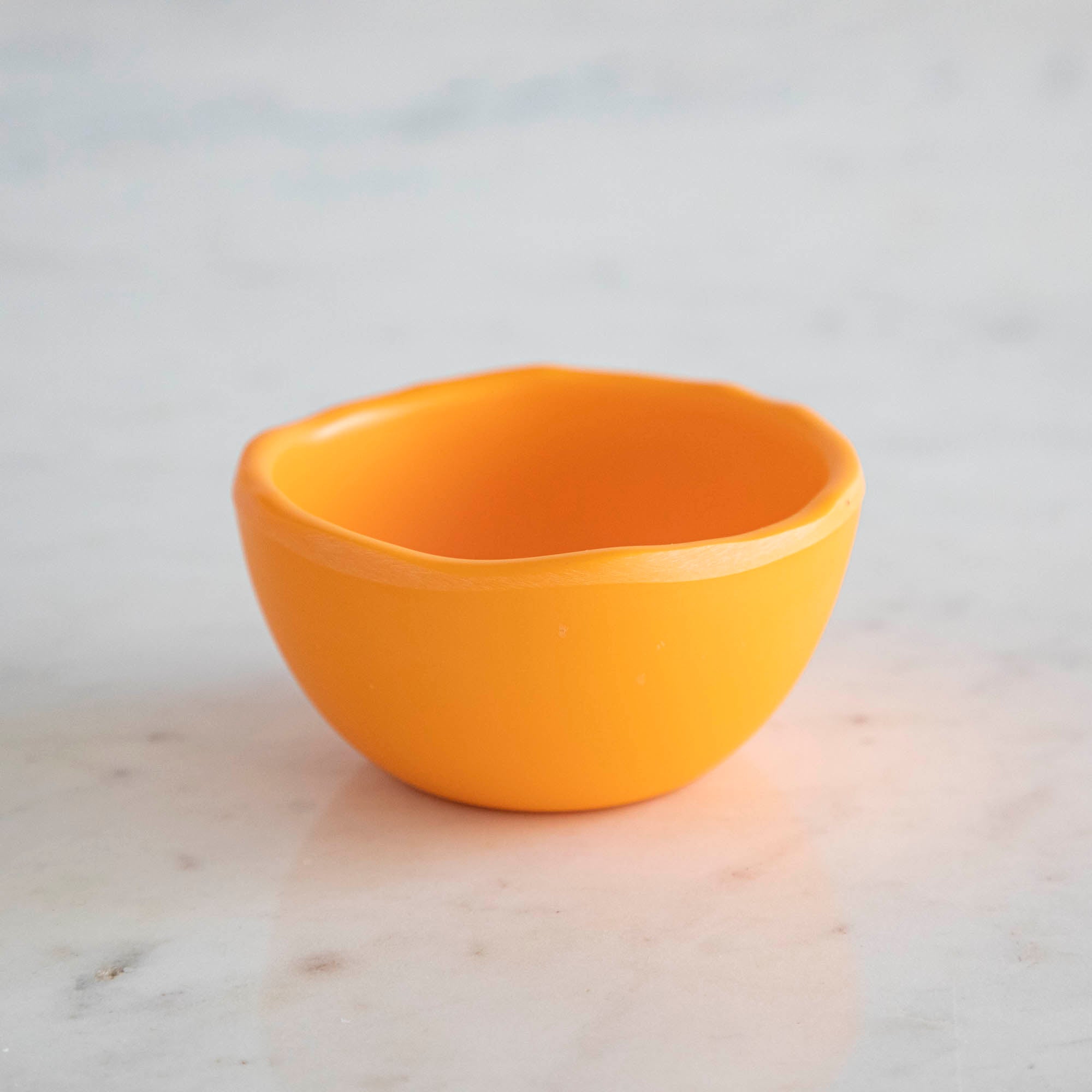 A set of colorful, dishwasher-safe Glitterville Rainbow Melamine Trinket Bowls on a table.