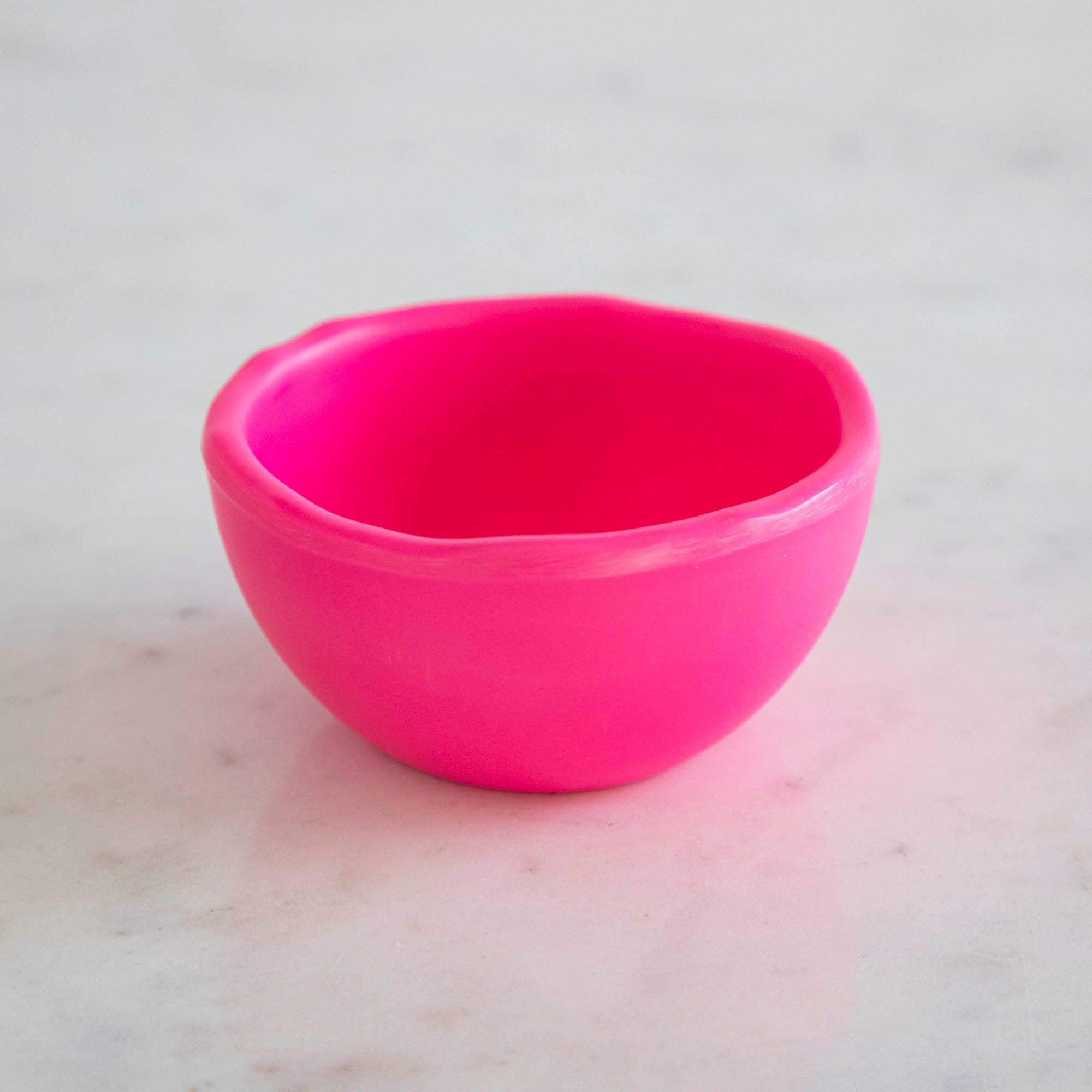 A set of colorful, dishwasher-safe Glitterville Rainbow Melamine Trinket Bowls on a table.