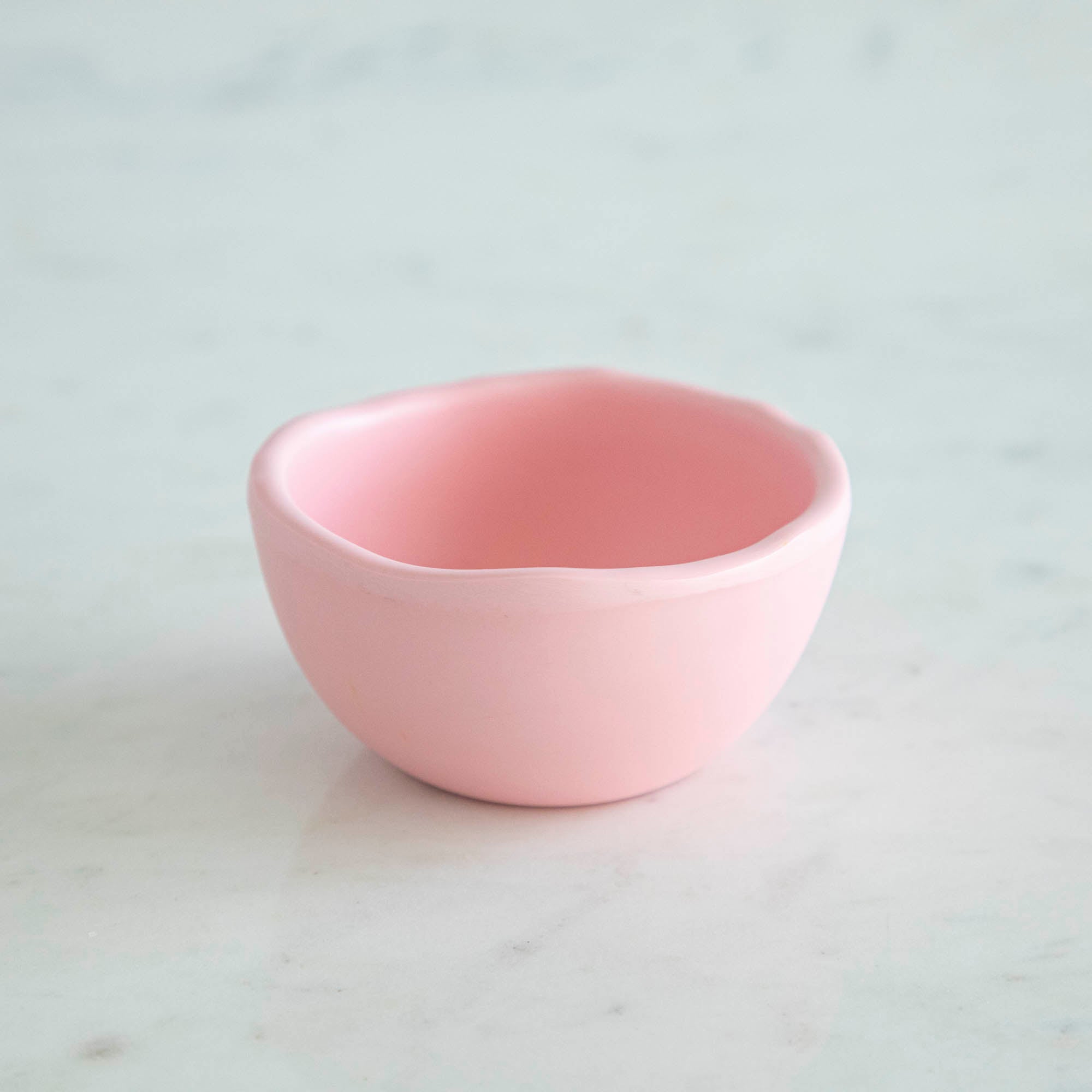 A set of colorful, dishwasher-safe Glitterville Rainbow Melamine Trinket Bowls on a table.