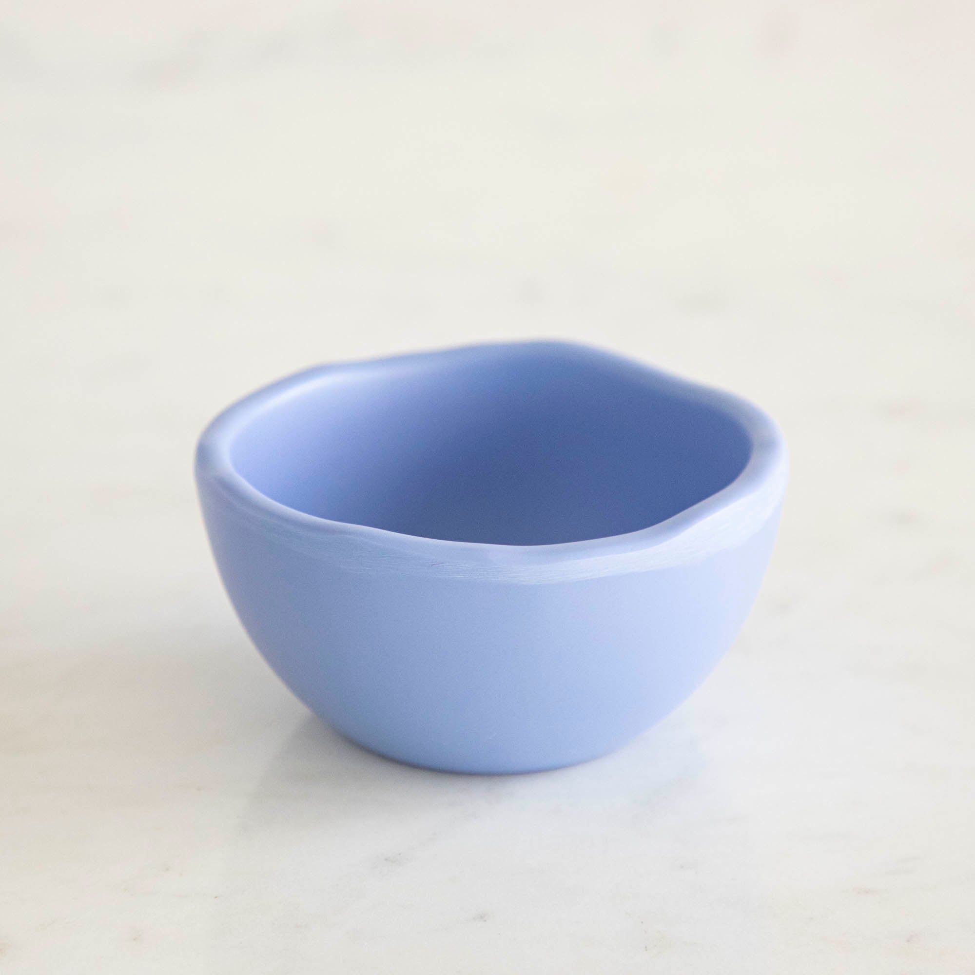 A set of colorful, dishwasher-safe Glitterville Rainbow Melamine Trinket Bowls on a table.