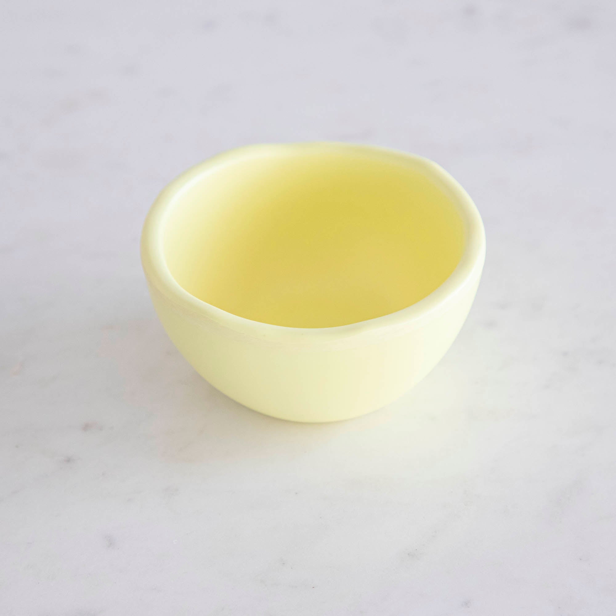 A set of colorful, dishwasher-safe Glitterville Rainbow Melamine Trinket Bowls on a table.