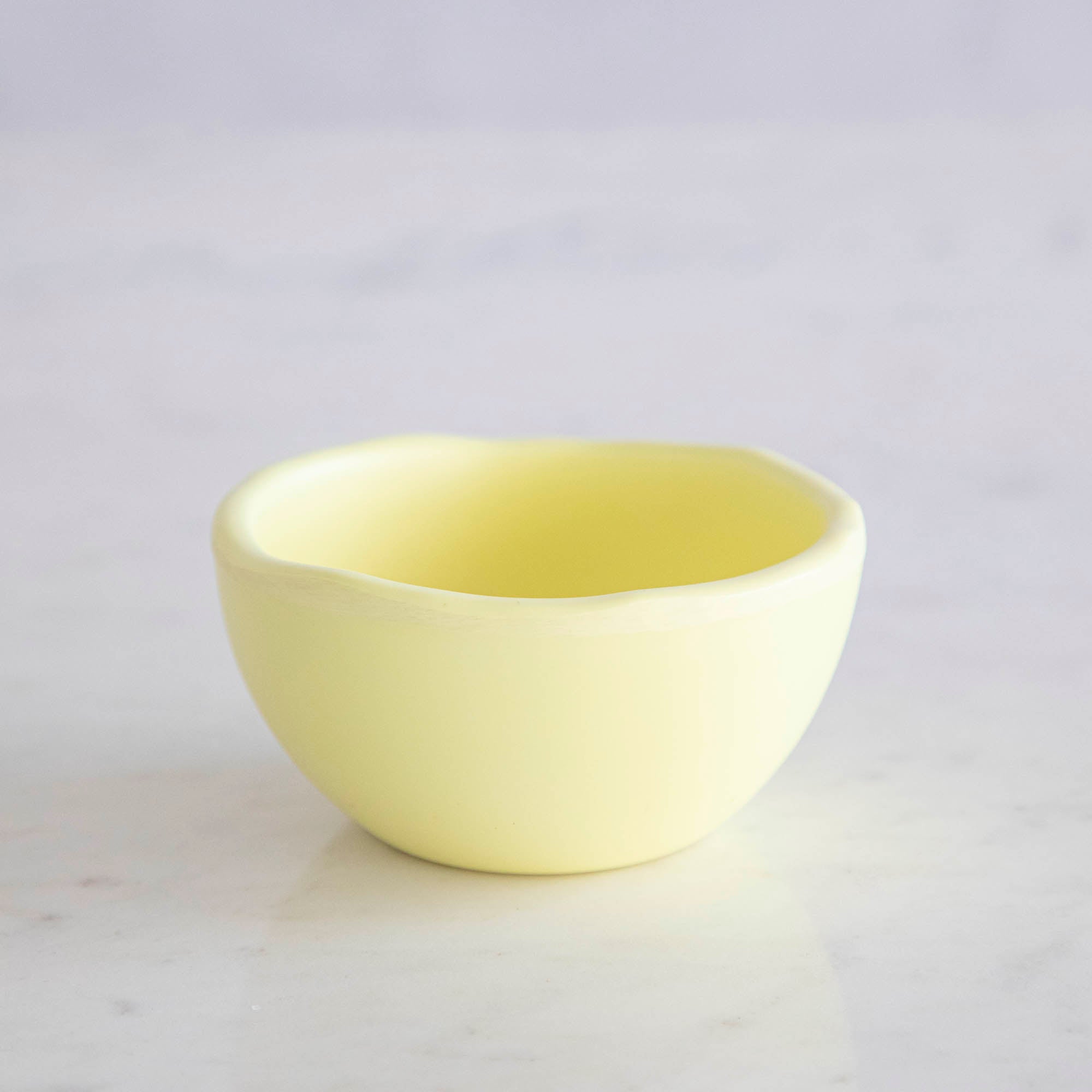 A set of colorful, dishwasher-safe Glitterville Rainbow Melamine Trinket Bowls on a table.