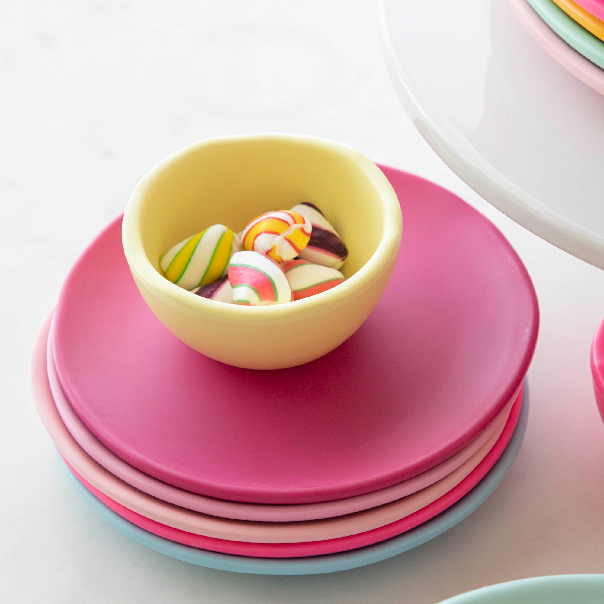 A set of colorful, dishwasher-safe Glitterville Rainbow Melamine Trinket Bowls on a table.
