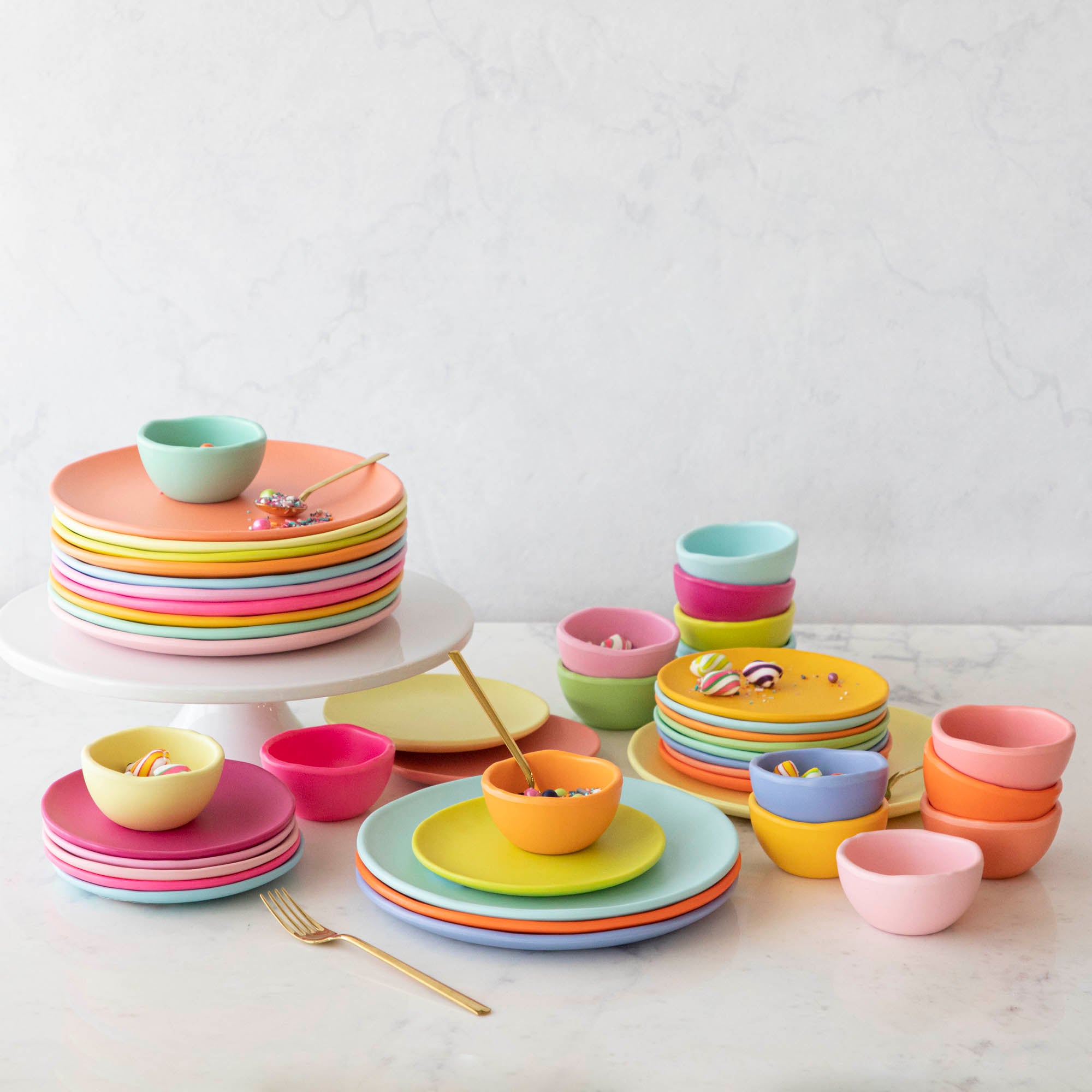 A set of colorful, dishwasher-safe Glitterville Rainbow Melamine Trinket Bowls on a table.
